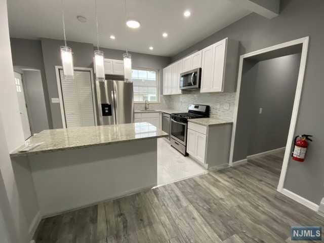 NEWLY RENOVATED SECOND FLOOR APARTMENT! Open concept kitchen into dining and living room. Big island opens up into dining room. All new stainless steel appliances. Two full new renovated baths. Three good sized bedrooms with closet space. Two attic storages!! SO MUCH SPACE!! One car spot available in driveway. Street parking. Pets Ok/Conditional. Washer/dryer in unit. Close to transportation! DO NOT MISS OUT ON THIS GREAT APARTMENT.