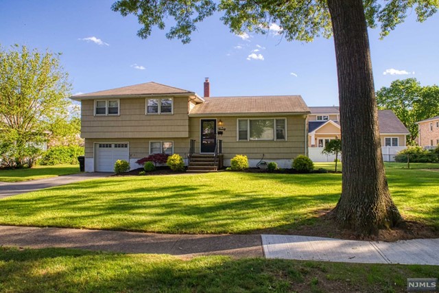 Well-maintained split level with hardwood floors throughout. The ground floor features a family room and powder room. The first level has a large living room with lots of natural light, a formal dining room, and modern eat in kitchen. The master bedroom features a powder room with an additional 2 good-sized bedrooms and a modern full bath. Park like private back yard is perfect for entertaining! Top rated schools. Close to highways, transportation and shopping! Central air.