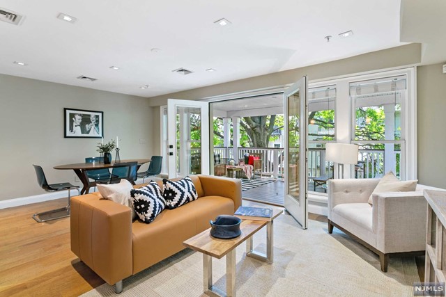 Divine indoor-outdoor combination in this beautifully designed award winning home in Paulus Hook. 2014 award winner from JC Historic Commission for cutting edge authenticity features modernity & classic preservation. Roomy 1BR/den/1.5 baths w/200sf covered deck off living area w/large double doors expands living area effortlessly combines indoor-outdoor spaces for a dynamic setting. Cutting edge ADT Pulse & smart home enabled and green hydronic heating & hot water on demand. Customized interior design includes mahogany cabinets & built-ins, LED lighting throughout, hand finished ' sawn 5'-wide oak plank flrs, custom glass tile backsplashes, Jenn-Air appliances, Whirlpool Duet W/D room, Caesarstone counters & gorgeous baths. Full bath boasts large standing shower, floating vanity & heated tile floors, en suite w/large walk in closet. Classic style deck made of maintenance free TimberTech composite material w/hidden fastenings, ceiling lights & fans perched among 65' tall oak tree.