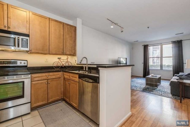 Welcome to Hudson Club at Port Imperial. An exceptional riverfront community is located along the NJ Gold Coast minutes from the Port Imperial Ferry Terminal. This 1 BR, 1 Bath modern condo is approx. 767 sq ft with a quiet outdoor private balcony over looking a gorgeous garden court yard. Open floor plan with great flow. The kitchen features granite countertops, stainless steal appliances. Hardwood floors can be found throughout the home. Lovely updated bathroom with access from the bedroom as well as from the living area. 1 outdoor assigned garage space included. Building Amenities: Fitness center, pool, basketball courts, tennis court, playground, clubhouse & concierge. Residents at the Hudson Club have easy access to the NY via the Waterways Ferry, NJ Transit Bus. Shops, restaurants and nightlife nearby. Pet friendly building.