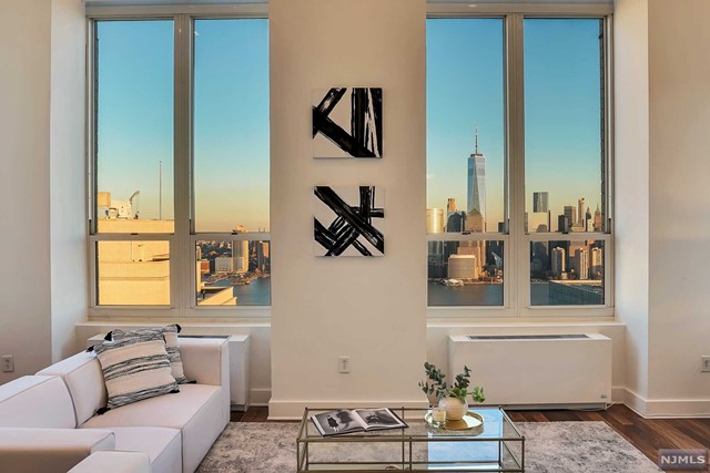 This spectacular & unique Penthouse is a feast for the senses! From the moment you enter the grand lobby until you reach the threshold of your sleek, chic residence you feel the difference of what a luxury lifestyle is. Chef's kitchen with NYC sight lines through the 15' windows in the living room flowing into the majestic 22' ceilings, banquet-sized dining room & breathtaking panoramic skyline views to relish and appreciate. Offering 3 bedroom / 3 baths with abundant storage & closets. To add to the experience - your own private elevator delivering you to a rooftop terrace overlooking NYC's historic skyline with Hudson River views from the Verrazano to the GWB, perfect for entertaining or relaxing after a long day. Expansive terrace is equipped with a waterline, gas line & storage. Amenities feature: Doorman & Concierge, pool, spa, gym, media & games room, residence lounge with kitchen & parking available. A treasure to behold, a location to be envied, a home to be desired.