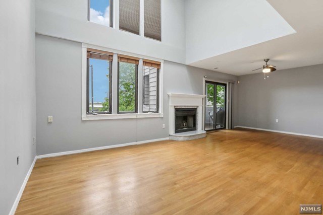Bright 3 floor townhouse located in Harmon Cove IV. Offering airy living space w/ high cathedral ceilings, tall windows, 2 walk out decks from 1st and 2nd floor. 1,704SF of open floorplan awaits you! Enjoy the spacious living room with a deck facing the tennis court/NYC. Kitchen is updated with stainless steel appliances. W/D room is accessible from the kitchen. Newer updated baths. On the 2nd floor, the 2nd bedroom has a private deck for your lifestyle & enjoyment. The entire 3rd floor is a serene oasis of space and privacy as a primary en-suite. Private storage unit is located on the ground level by the 2 car (tandem) parking. Gated community with 24hr security, HC IV has access to a pool just steps away from the unit. Enjoy the trails for biking, or for a stroll. Easy access to NYC transportation steps within the community.
