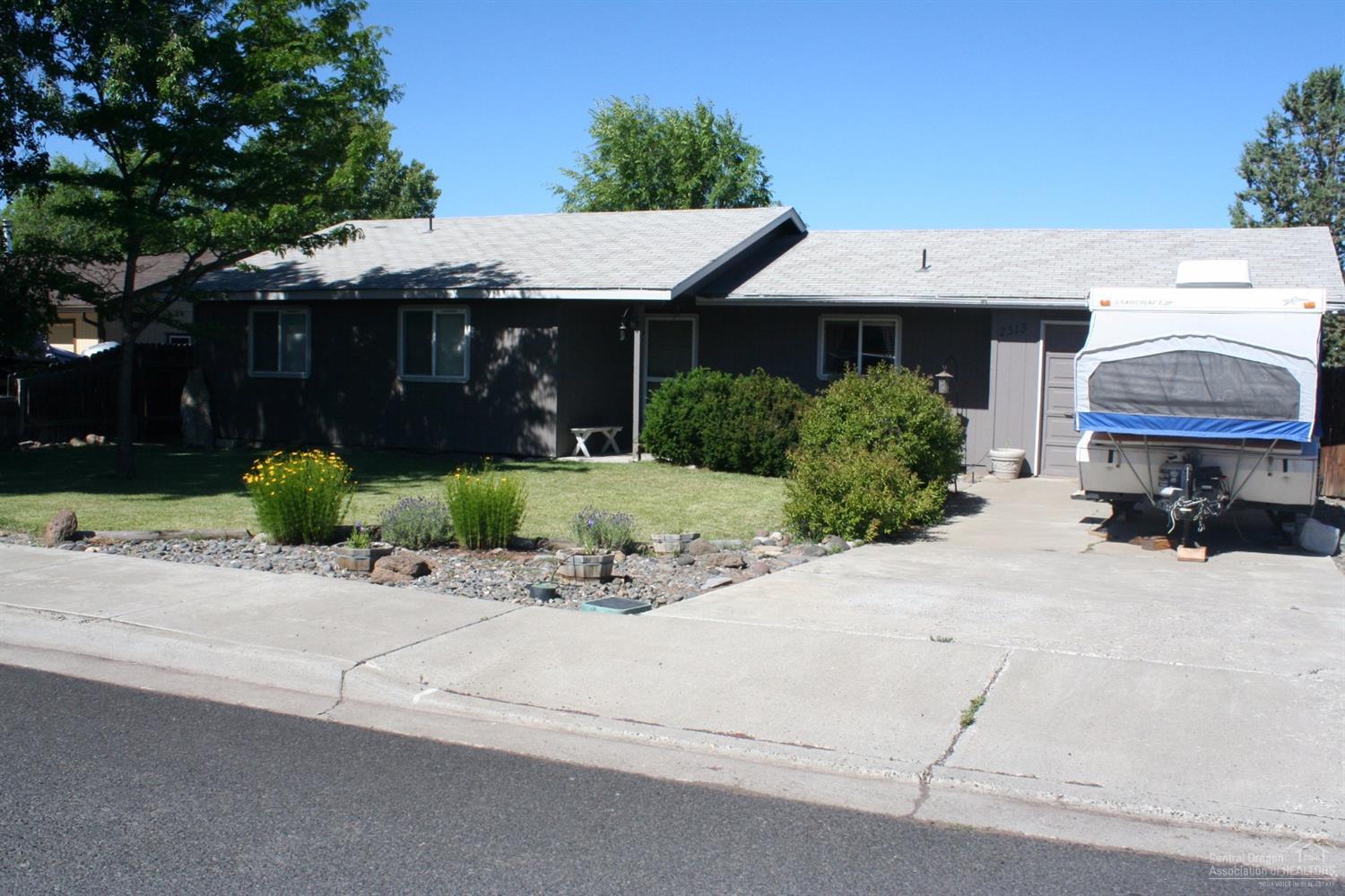 Southwest Redmond home, located on large corner lot, fully fenced backyard. Light and bright home features a pellet stove to keep you cozy in the winter. This home has had the garage converted to living space, which adds 336 square feet, can easily be converted back to a garage if desired. Seller will install new roof prior to close or can be credited towards purchase price.