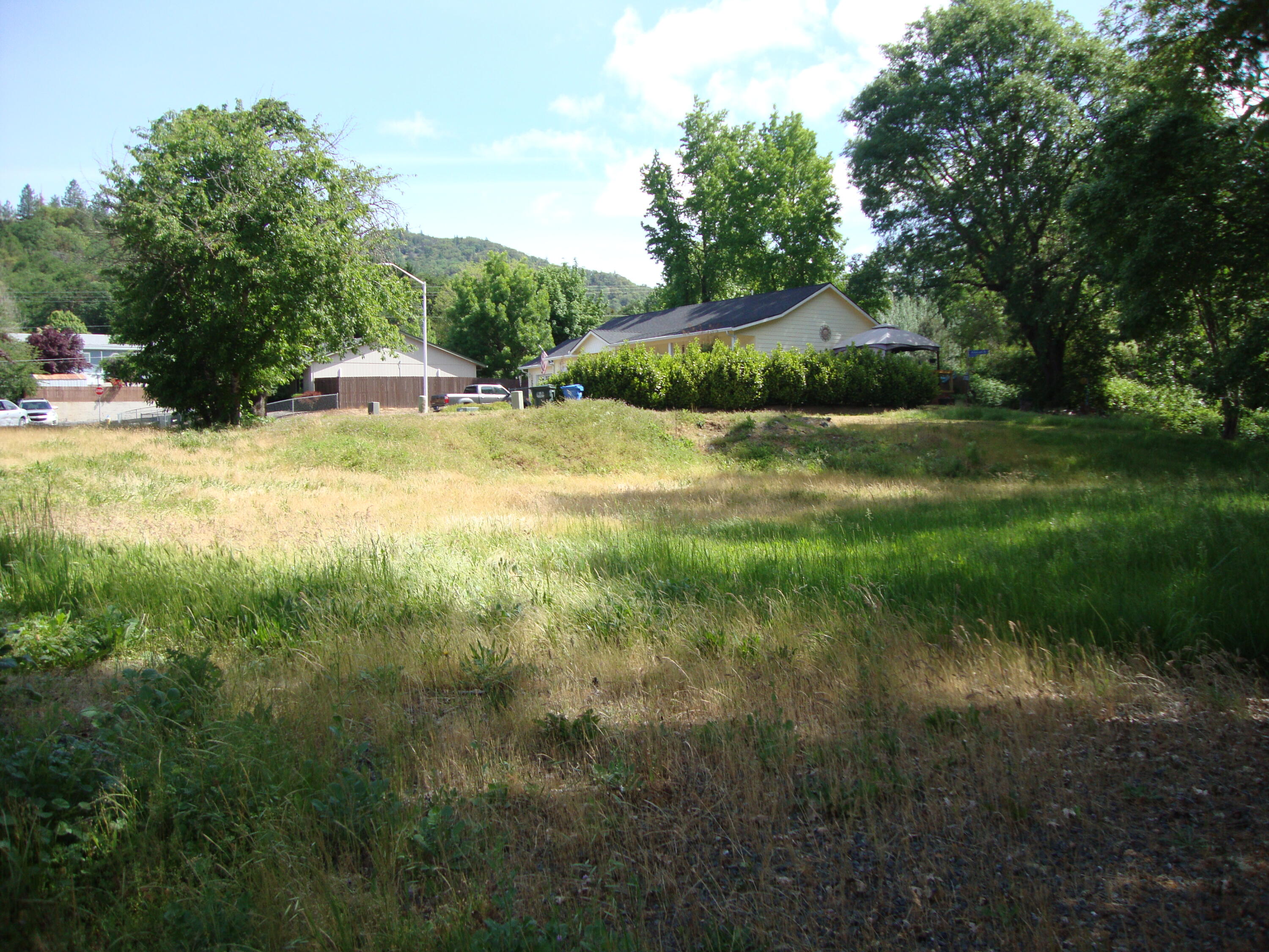 Opportunity awaits to build in the beautiful little city of Rogue River. Property is located in a quiet cul-de-sac and backs to Wards Creek. City services are stubbed out at curb to include Natural Gas, Electricity, Sewer, Water, Phone and Grants Pass Irrigation. CC&R's are flexible and will allow a M/H. See City of Rogue River Planning for site requirements and details. Buyer to do due diligence.