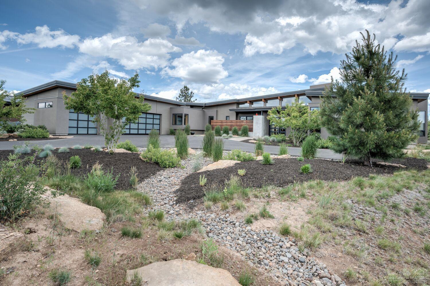 Stunning luxury contemporary home wins the Trifecta: amenities, floor plan, condition. Master suite plus 2 en suites work equally for a couple or a family, theater room, office. Remarkable wood ceiling, 7' plank oak hardwood flooring in Kit/Great Room, accordion door wall w/ clerestory windows graduating along butterfly roof line, natural light everywhere, wool carpeting, luxury mud room, over-the-top storage but then...the whole home is over the top! Outdoor kitchen with gas fire pit. 996 sf garage.