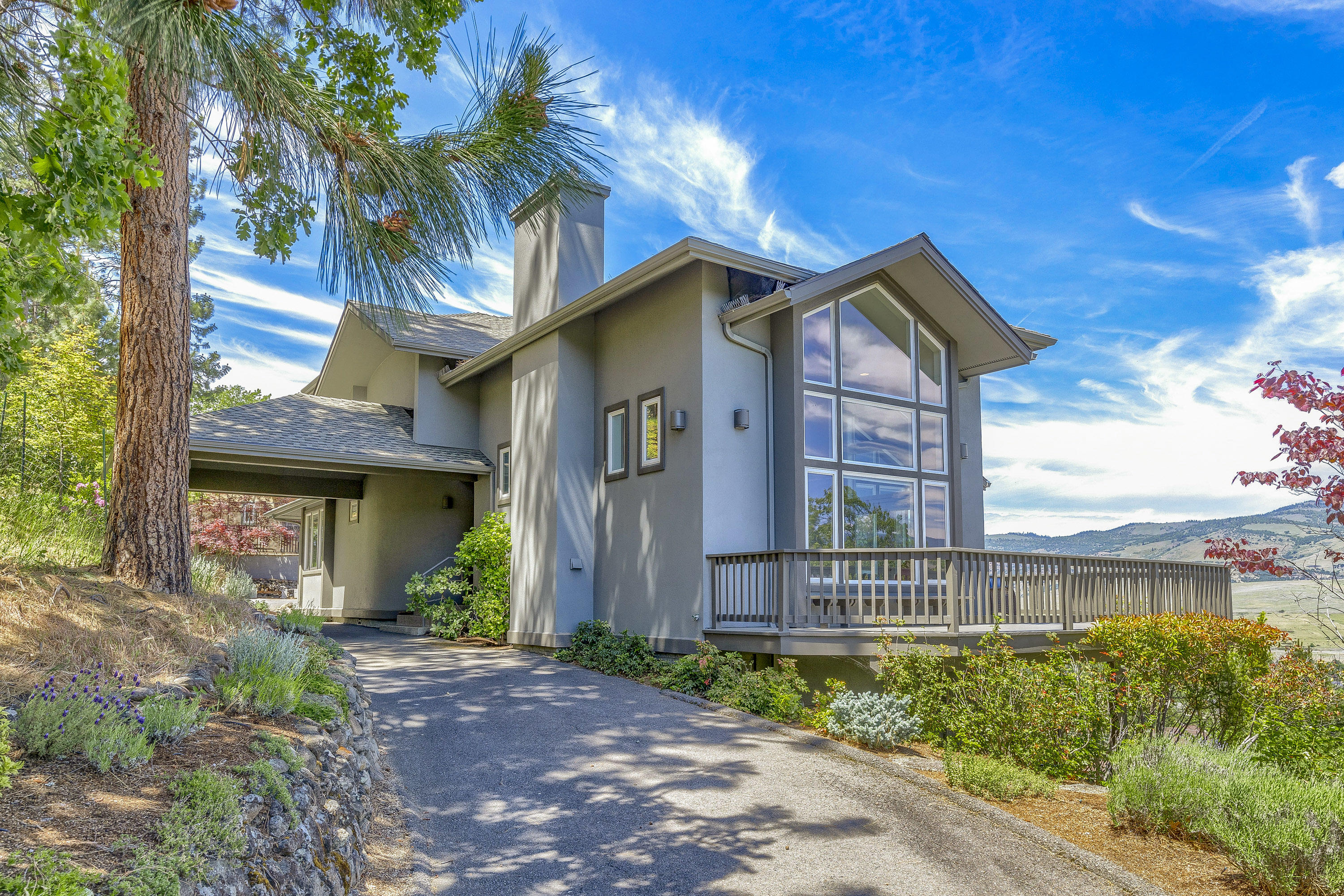 Sophisticated & stunning home with breathtaking expansive views of the city below and mountain range afar. Upon entering the home from the port-cochere, one is met with beauty and grace as the architectural features outline the soaring ceilings, walls of windows and sunken living room with marble surround fireplace. This is an excellent home for entertaining, chef's kitchen has lots of counter space, island with cook top and opens to great room on one end and spacious dining area on the other. The large wrap around deck is perfect for all of your outdoor enjoyment. Main level has guest bedroom and bath. Upstairs has another bedroom w/ bath, office nook and a relaxing master suite with fireplace, balcony and a luxurious master bath with deep soaking tub, dual sinks and a gorgeous glass enclosed shower of Schist Stone w/ quartz vein. Home has been meticulously maintained including recent professional paint job inside and out and new 50-year roof installed in 2015. This is one of a kind.