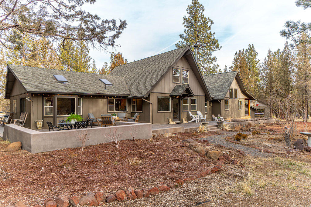 Experience the NW Bend lifestyle from this private 5 ACRE property located minutes to Westside schools, Downtown and Shevlin Park. Charming and recently updated home offers over 3000 SF plus an additional 1320 SF detached Studio AND Shop with 2 generous spaces ideal for secluded Home Office or Artist. Great Rm w/ light-filled windows, vaulted wood ceilings, and a delightful dining area w/cozy window seat overlooking the Ponderosa Pines. Cook's Kitchen offers solid surface countertops, sleek backsplash and new SS appl. Front Living Rm w/woodstove and exposed beamed ceilings. Spacious Main Level Primary Suite features vaulted ceilings, sitting area and access to covered, back deck. Primary BA w/dual vanity, soaking tub and tiled shower. 1 additional BR, full BA + flex space on main. Upstairs: Fabulous loft Bonus Rm and Bedroom with ½ BA. Multiple outdoor patios and decks to enjoy year-round. Truly a rare opportunity, an inspiring setting and an outdoor enthusiast's dream location.