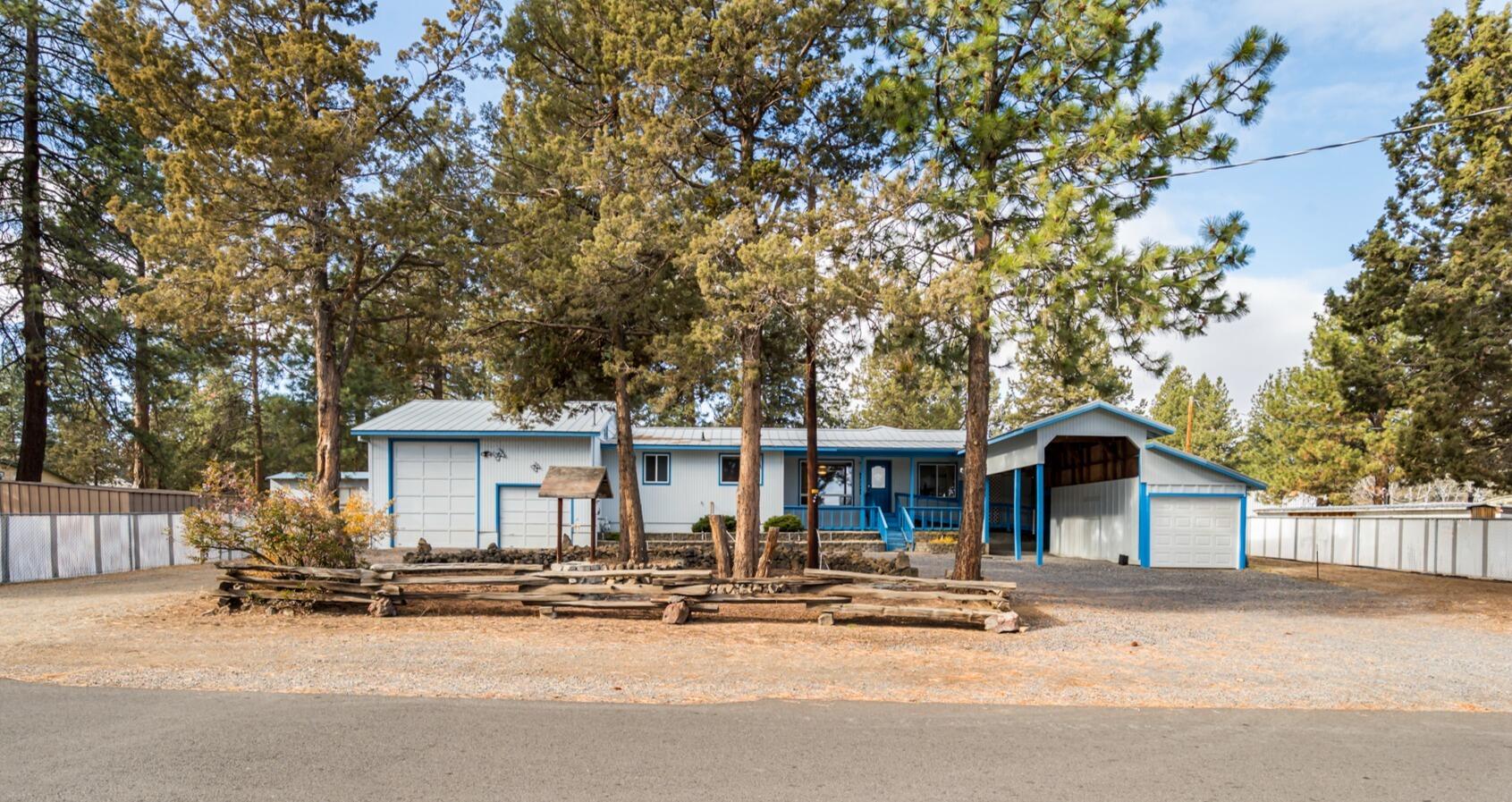 True pride of ownership shows in every detail of this home! Located directly across from Tillicum Village Park on over 1/3 of an acre, this two-bedroom, one-bath home has had several upgrades. The living room has vaulted ceilings, a gas fireplace, and floor-to-ceiling windows, which allow for an abundance of natural light to shine through.  The property has an oversized garage with room for a shop, an RV, and an additional bonus room/bedroom upstairs.  Enjoy the quiet sounds of nature under the covered patio in the fully fenced backyard. Don't miss the additional shed, carport, water feature, and your very own root cellar. The possibilities are endless with the conveniently located home on this rare larger lot in SE Bend.