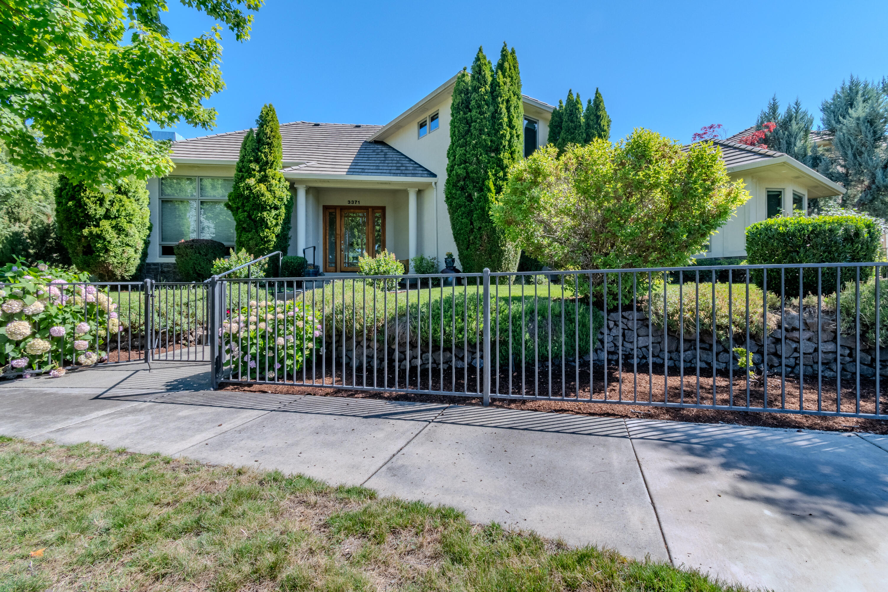 EXPERIENCE LUXURY LIVING ON THE GOLF COURSE in the highly sought-after Island Pointe Community! Perfectly positioned along the 5th and 12th holes of RVCC, this 3,025 sq. ft. Mahar-built home is filled with elegance and timeless design. Enter to beautiful slate floors that open into a breathtaking, light-filled great room featuring soaring ceilings, walls of windows, and a dramatic floor-to-ceiling fireplace framed by custom built-ins. The gourmet kitchen boasts granite slab countertops, stainless steel appliances, hardwood floors, and a sunny breakfast nook, while the formal dining room is enhanced with custom wine storage complete with a cooling system. The main-level primary suite offers a spa-like retreat with double vanity, soaking tub, shower, and walk-in closet. Upstairs includes a spacious loft/office, two bedrooms with stunning views, and a full bath. An oversized 2-car garage with storage connects to a large laundry room for convenience. Don't miss out on your forever home!