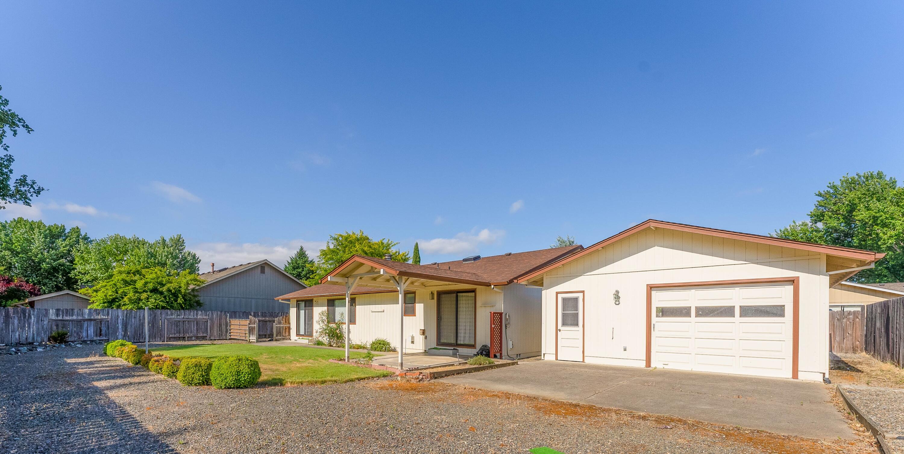 Unlock the potential in this conveniently located property in town on an oversized 0.21 acre lot with a ***SHOP & SEPARATE 2 CAR GARAGE*** It's a DIY enthusiast's dream. The 1,500sqft home, with 3 bedrooms & 2 bathrooms, offers ample potential. The spacious living room is flooded w/natural light, & an elevated dining area adds a touch of elegance. A cozy breakfast nook & a kitchen featuring rich wood cabinets, a range/oven, & a built-in dishwasher await your personalization. The master suite easily accommodates a king-size bed, with a walk-in closet & a master bath boasting a shower. Two additional bedrooms offer flexibility, & the hall bathroom includes indoor laundry. Outside, the expansive backyard is your canvas, with a sizable covered patio for BBQs, all within a fenced area for privacy. High-speed internet is available. Tucked in a quiet cul-de-sac, this property is full of potential. Water is from the Darneille Estates Community Water System.