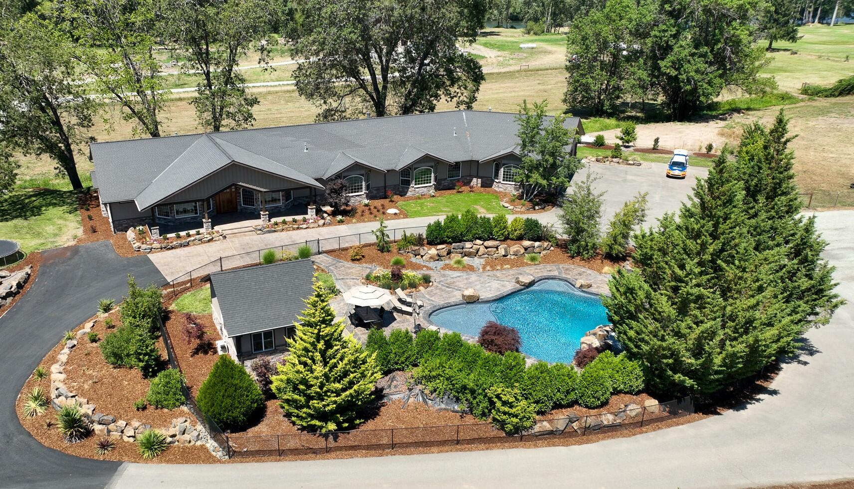 Stunningly renovated 5277sf custom home on 5 acres with lagoon style pool and Rogue River views. This exquisite estate boasts 4br/5ba, office, formal dining, gym, 2 pantries, office, family room and a grand living room with picturesque views. Spacious kitchen w/island, gas thermador 6 burner range, stainless & all the cabinetry you need. The master is a dream for all with a drop in soffit ceiling, massive walk in closet and magnificent step in shower. Oversized hallways connect the spacious split floor plan w/9' ceilings & granite counters throughout. 4 car oversized garage includes add'l storage & half bath. Gated paved circular driveway w/custom stamped concrete finishes & entry. A one of a kind 9' deep lagoon pool w/hot tub, massive basalt boulders & pool room fully fenced with privacy. 2300sf barn built 2016, fenced area for animals & lower irrigated pasture. Mature custom landscaping & high producing well.  All information is deemed reliable but not verified or guaranteed.