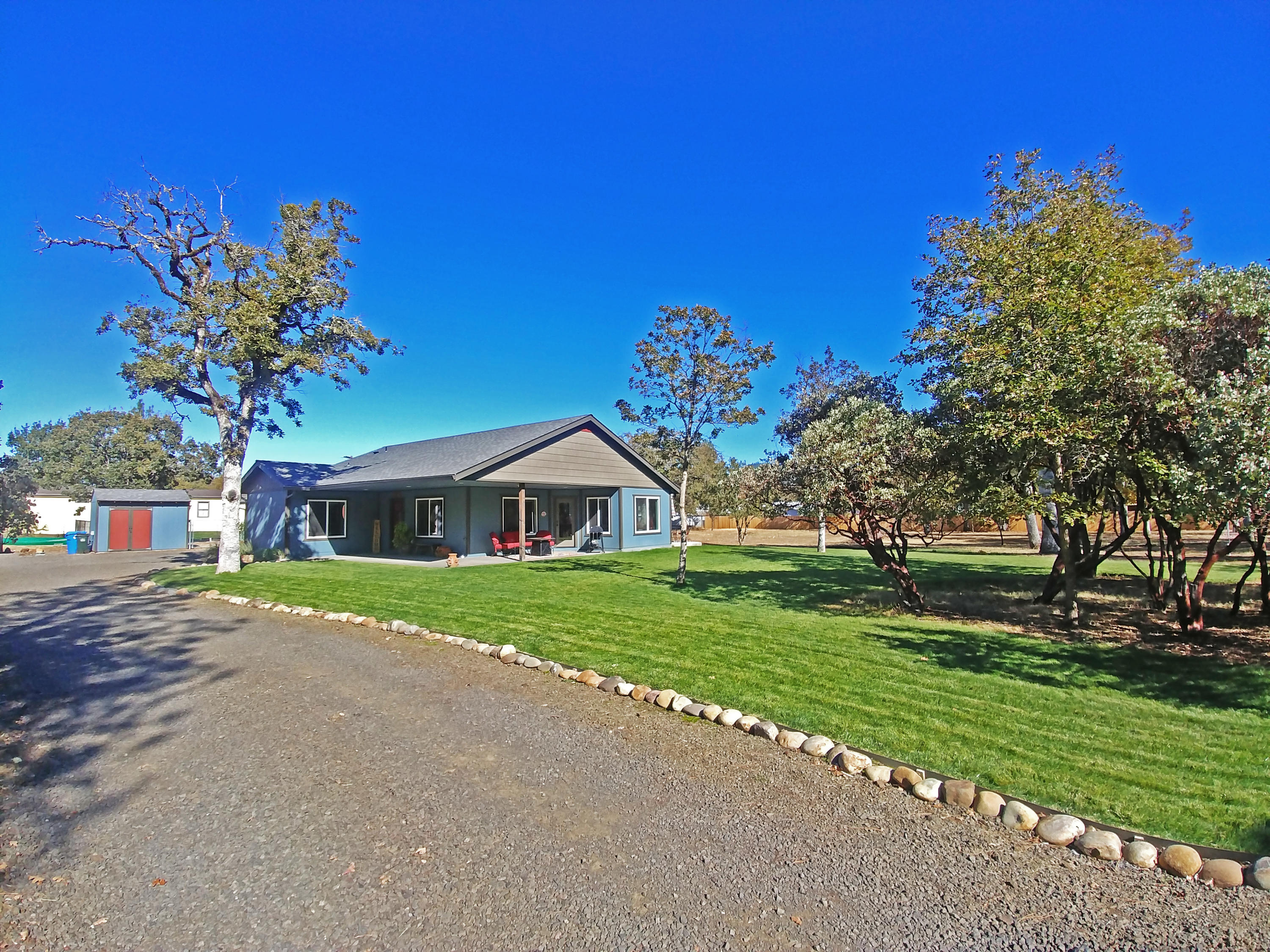 Luxury at an affordable price! Near-new custom built on almost 2 flat usable acres. Good well w/good water, great location, country living yet life's necessities are nearby! Minutes to rafting, fishing & hiking, 25 min to Medford. Great room w/vaulted ceilings & tons of big windows bring outdoors in. Views of yard, manzanita grove & ample wildlife. Gorgeous kitchen w/ample counter space & eat bar. Kitchen & baths w/beautiful broken edge granite & custom knotty alder cabinets. Custom touches throughout! Master w/large walk-in closet w/custom organization. Master bath w/dbl sinks & large tiled walk-in shower. Oversized 2 car garage, insulated w/tiled wash station, work bench & cabinets. Private covered porch/patio, keeps the hot sun out on hot days! 9K SF lawn w/timed sprinklers--green all year! Fire pit tucked in manzanita grove. Garden w/raised beds, big fenced dog area off garage, shed w/water & electricity! RV parking w/power & sewer hook ups. New fencing! Private quiet location!