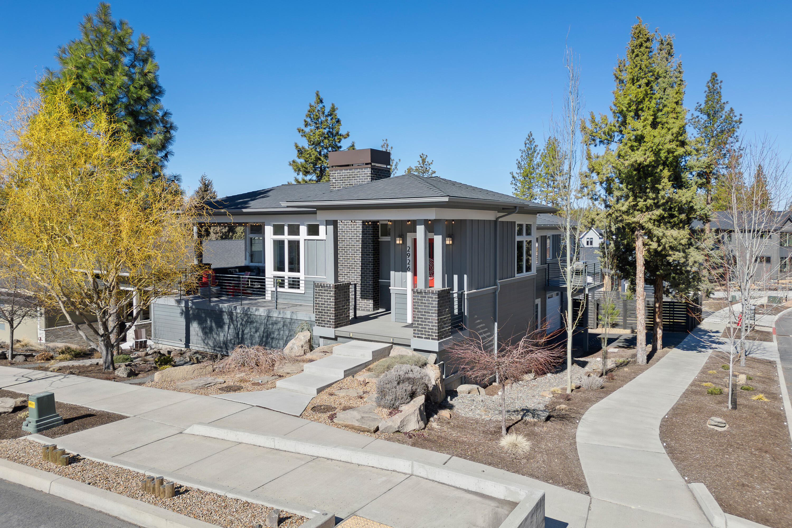 NW Contemporary home with vaulted ceilings and abundant windows to usher in natural light.  SINGLE LEVEL living with all the bedrooms on the main level and a 23 x 18 BONUS ROOM downstairs. Peek-a-boo CASCADE VIEWS from the Westside of home.  Great room with gas fireplace opens to the outdoor living space with built-in heaters and sunshade perfect for enjoying the sunsets. Well-appointed kitchen with island, quartz counters, SS appliances to include a 5-burner range & wall oven, pantry and door to a balcony perfect for BBQ's. Bright office with French doors.  Primary bedroom suite with walk-in closet, walk-in shower, soaking tub and double sinks.  Wood floors throughout the main level. 600 SF garage plus a 364 SF storage room with dual access.  BONUS ROOM  above Storage (23x18). Professional landscaping with a water feature and large fenced backyard. NO HOA. Near Talline subdivision, slated for a park and mixed commercial businesses.  Close to Shevlin Park and trails.