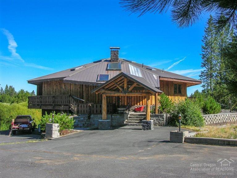 Sunriver Area Log/Frame Home on 2.26 Acres on the River! This one-of-a-kind riverfront home offers: great room w/soaring vaulted ceiling, extensive Blue-Pine accents, skylights, floor to ceiling stone hearth & pellet stove, front family room w/bar & spectacular river views, elevator/dumb waiter, open kitchen/big dining area w/B-bar, main level master w/tiled bath & walk-in, 500ft of river frontage + dock, big shop + log building, green house, large paved drive & parking w/security gates, 1 yr home warranty!