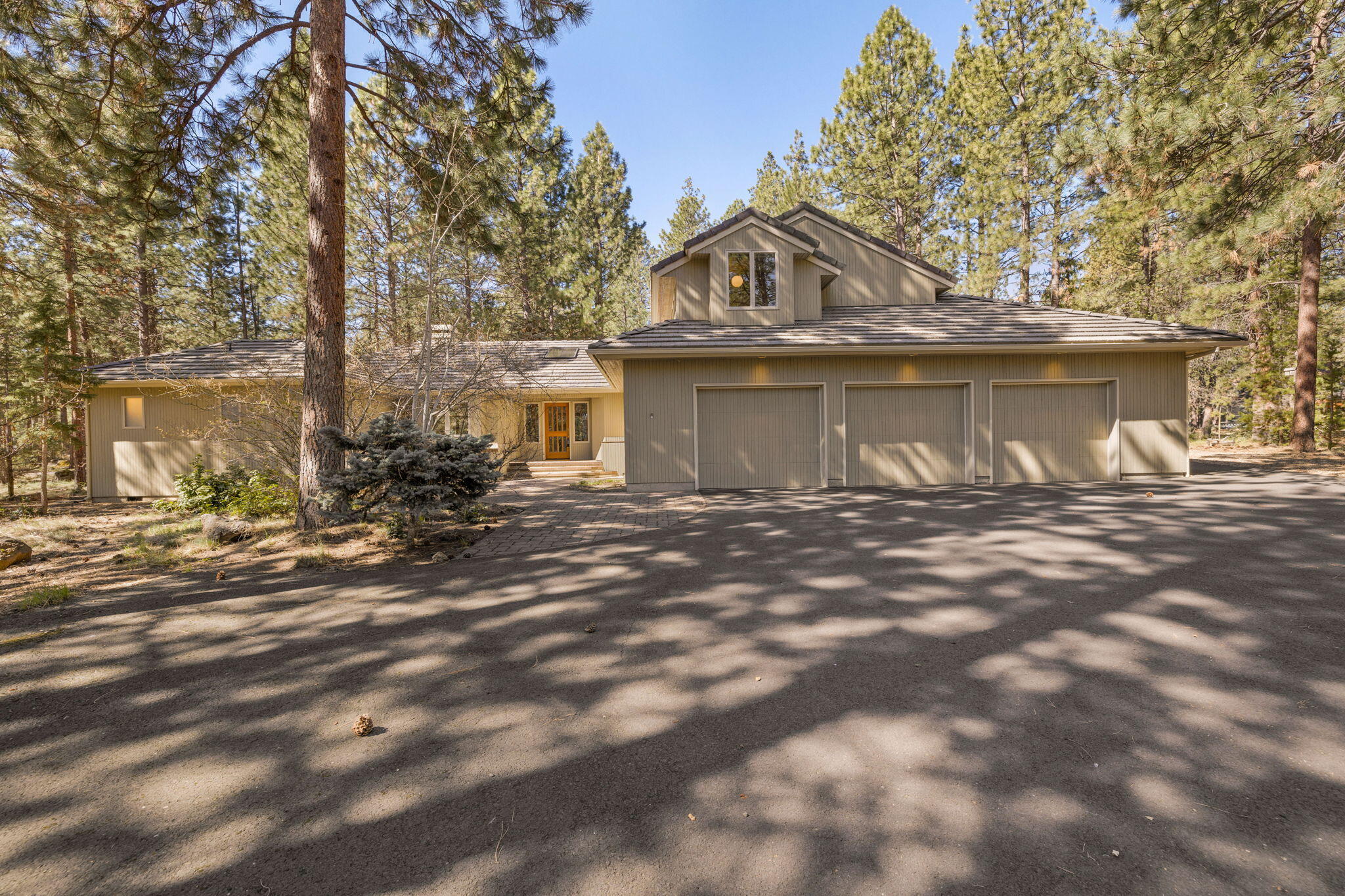 Nestled in the coveted Sunrise Village neighborhood, this home is ideal for exploring nature right outside your door. Living like a single level with a private primary suite on the main floor, the high ceilings of the great room continue throughout the open floorplan filling the home with natural light. The kitchen is enhanced by extended counter height seating and an overheight architectural window looking out to the private backyard and expansive ground level deck. An additional main floor bedroom and bathroom are on the opposite side of the home, with a third bedroom and bathroom integrated into an upstairs bonus living area. Oversized 3-car garage includes room for a workbench, attic storage, as well as a partially covered and fenced exterior area providing flexible options for gear. Neighborhood amenities include community pool, tennis courts and dog-walking trails with private access to the Deschutes River.