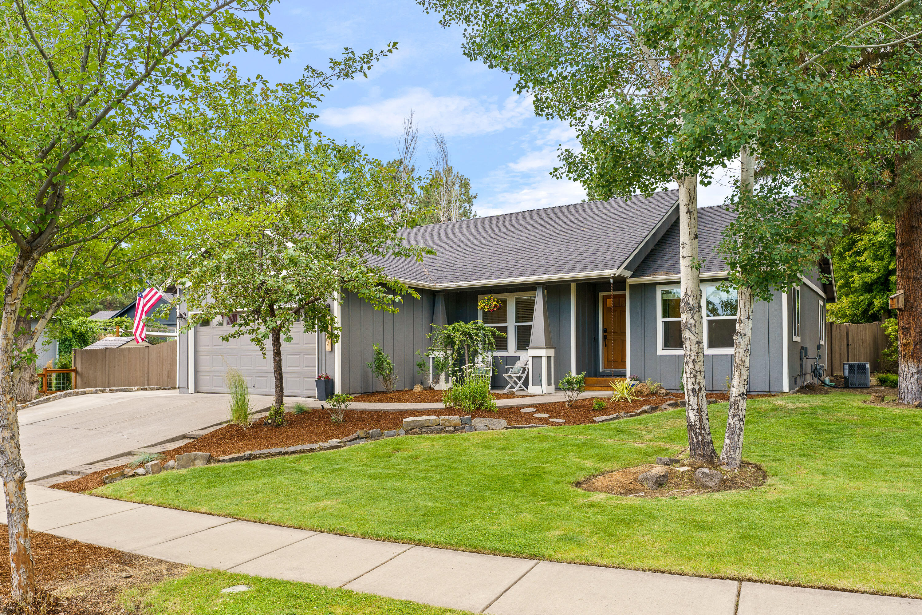 With standout curb appeal and a modern farmhouse vibe, this beautifully updated 3-bedroom, 2-bath home offers stylish and comfortable living on a generous 0.26-acre lot. Inside, vaulted ceilings and a south facing open-concept floor plan create a bright, airy atmosphere anchored by a cozy updated gas fireplace. The kitchen is outfitted with stainless steel appliances and blends seamlessly into the main living space-ideal for entertaining or everyday living. The spacious primary features a large walk-in closet and a beautifully tiled walk-in shower. Thoughtful updates throughout include luxury vinyl plank flooring, new lighting, and more. Enjoy peace of mind with a new fence, new roof, new central A/C, new exterior paint. Step outside to a sprawling, park-like backyard-perfect for play, gardening, or just relaxing. This home is move-in ready and full of charm inside and out.