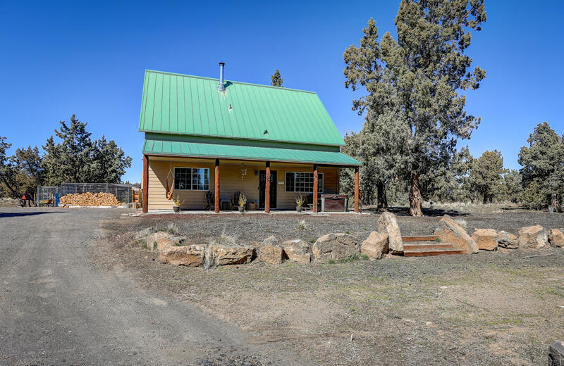 Come see this Charming 3 bed 2 bath 2016 sq ft craftman style home on usable 6.5-acre treed property great for dogs, chickens, goats.   You will love this horse potential property out in the country yet close to town with the freedom of no HOA or CCRS restrictions and low property taxes.  This amazing home & property feature RV/Boat Parking, Space for a Shop/Garage, Fenced in dog area and fenced in goat area, Entire Property fenced, Chicken Coop, Woodstove, Covered Front Porch w/ beautiful log accents, Railroad Container, Metal Roof, Hot Tub. Fast Fiber Optics Broadband Internet Speed, Large Stylish Kitchen with Alder Cabinets & double ovens, Pantry area, plus an office & bonus room – could be 5-bedroom home with 2 closets added. All located w/ an easy drive to Medical, Costco, Shopping, and downtown Bend. A friendly community w/ lots of wildlife, deer, quail, chipmunks & chickadees.  Call today to schedule your private showing tour & your opportunity to own a place you can call home.