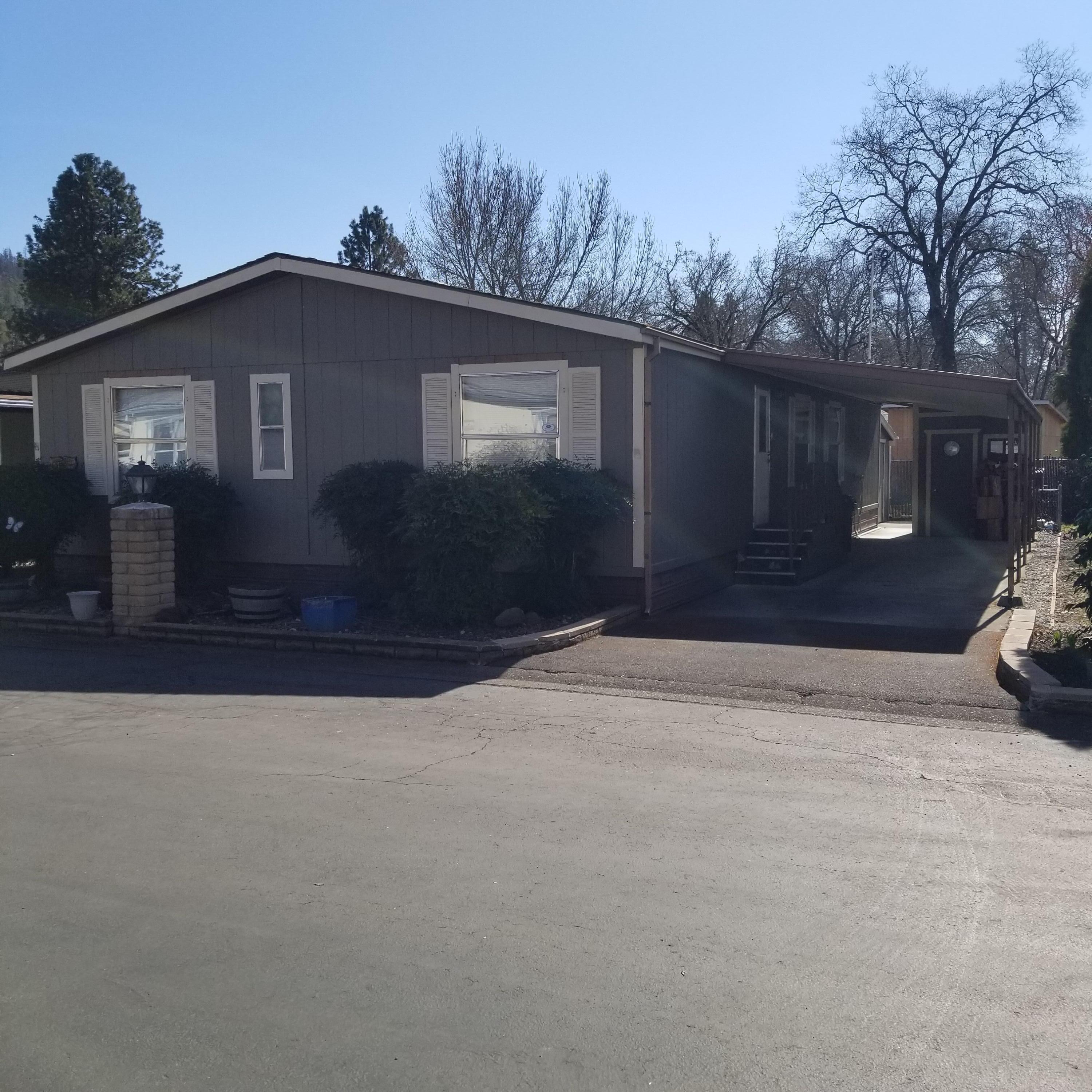 Neatly Kept home in a quiet 55 and over community with river access, parking for your toys and much more! The home features 3 beds and 2 full baths with an open floor plan and a roomy kitchen. There is a covered 52X8.5' front porch as well as a covered 44X11' carport with a 7X8 storage shed. In addition there is a 24X8 workshop with 110- 220amp outlet and covered 24X7 workspace in the backyard. Great place to live! Space rent is $571.00. MOTIVATED SELLER!