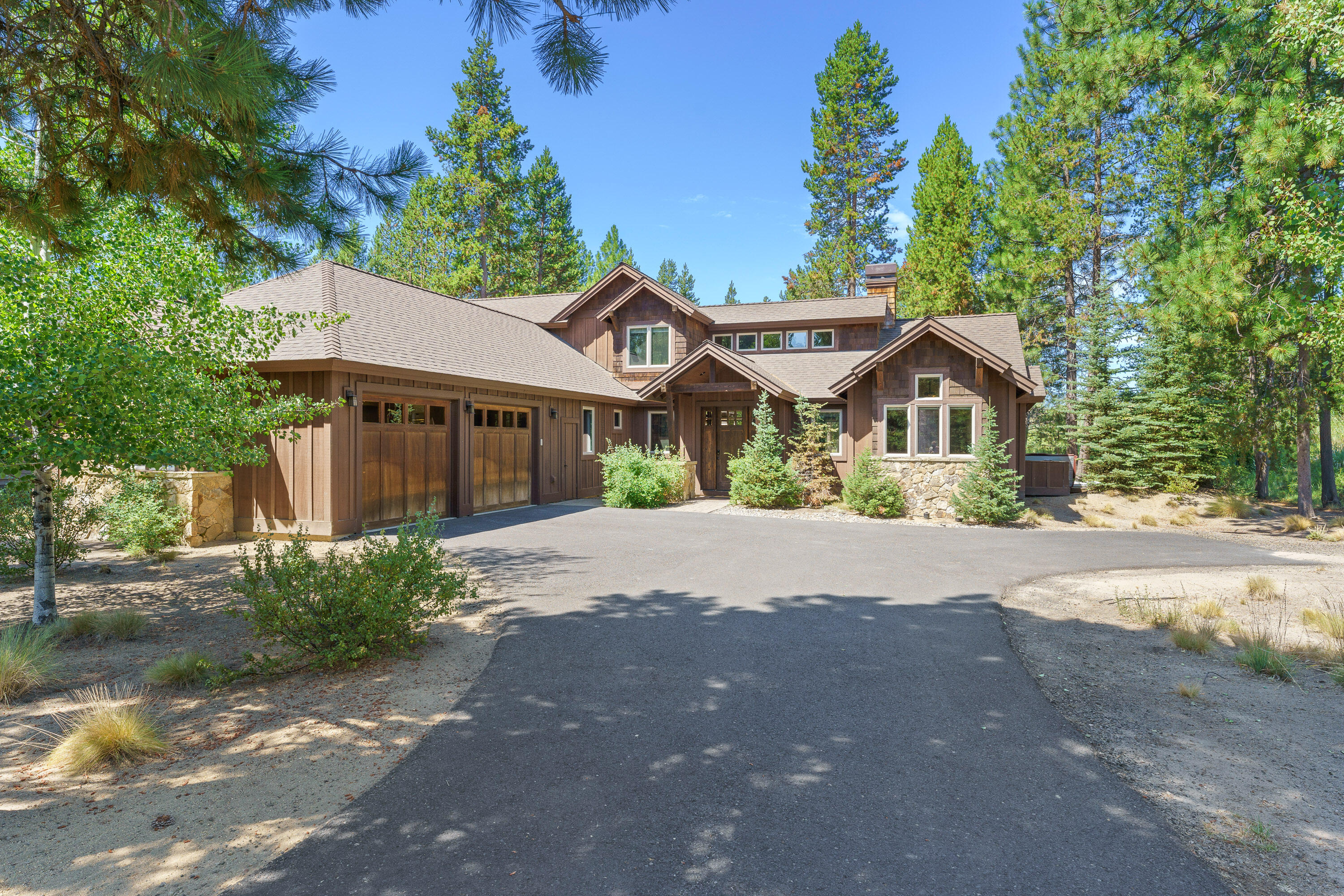 Welcome to your Caldera Springs basecamp! This beautiful home boasts soaring ceilings with a floor to ceiling stone fireplace, new hardwood floors and an open concept design - great for gatherings! A wall of windows looks out to the private greenery beyond the paver patio. Dine outdoors or enjoy a soak under the stars in the private hot tub before retiring indoors. The three main floor bedrooms include a primary suite with patio access and en suite bathroom, and two comfortable guest rooms. Head upstairs to find a spacious bonus-bunk room with it's own en suite bathroom! As an owner in Caldera Springs, you'll gain exclusive access to the Lake House, Quarry Pool & fitness, the brand-new Forest House, Caldera Links and more. Offered turnkey and ready to enjoy - whether you intend to continue using as a vacation rental or keep all to yourself!