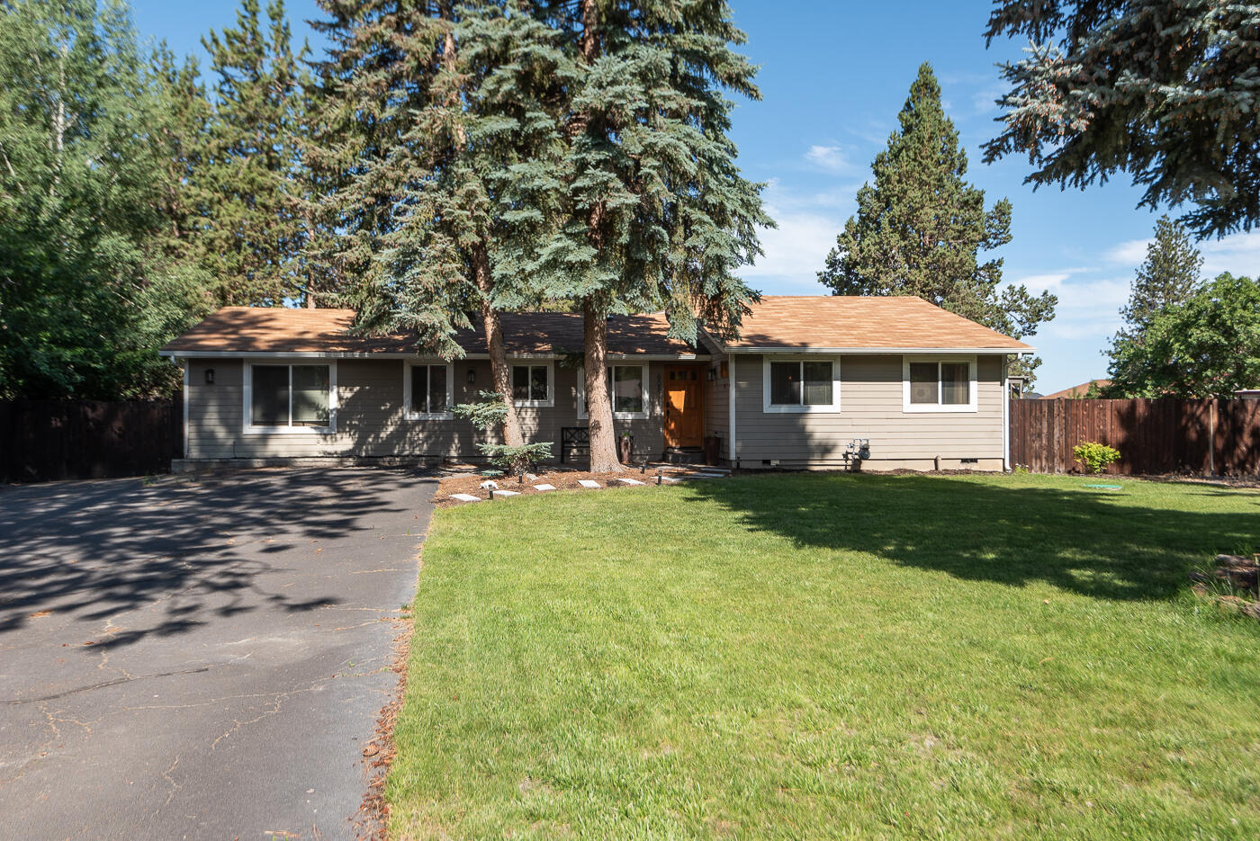 This stunning ranch style home boasts two primary bedrooms, each with their own ensuite bathroom. Additional two bedrooms are spacious and there is a full bath nearby. Open concept floorplan features a beautifully designed chef's kitchen with built in refrigerator/freezer, quartz counters, and movable island. Dining area is big enough for even the largest table. Living room is light and bright with a slider to access the backyard. The family room has a pool table and cozy gas fireplace; perfect for game nights. Outside is a fully fenced professional landscaped yard with mature trees, gated RV and or boat parking, 2+car garage that could be used as a shop. Sitting on just under 1/2 acre, this property has so much to offer. Only two blocks to the new Caldera HS, less then 4 blocks to Alpenglow Park and with downtown nearby, you will love the location as much as this home.