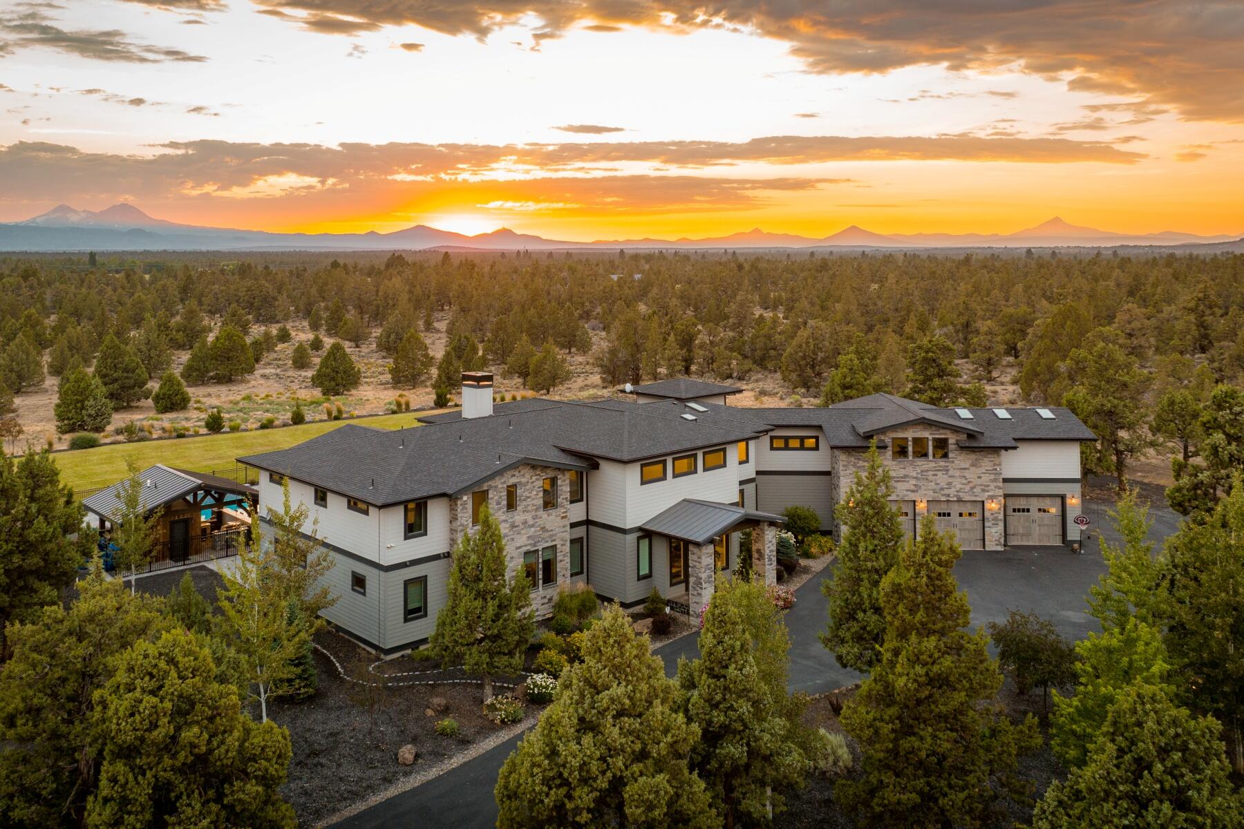 Presenting an extraordinary opportunity to own a sanctuary of sophistication and privacy without sacrificing luxury and convenience. Impeccably situated amidst the awe-inspiring beauty of the Cascade Mountains, this property delivers a lifestyle like none other. Upon entering through the regal, wrought-iron gates, you will wind through a serene landscape before coming to gaze upon the home's commanding façade. The interior is a testament to meticulous craftsmanship, adorned with hardwood floors, coffered ceilings, and artisanal fixtures. Step outside, and find yourself in an outdoor oasis with a resort-style swimming pool; complete with a built-in bar, sun shelf, swim-up bar area, surround sound system, and bathroom. For the equestrian or outdoor enthusiast, trails for horseback riding, hiking, and mountain biking are but a stone's throw away. Your search for the epitome of Central Oregon grandeur ends here.