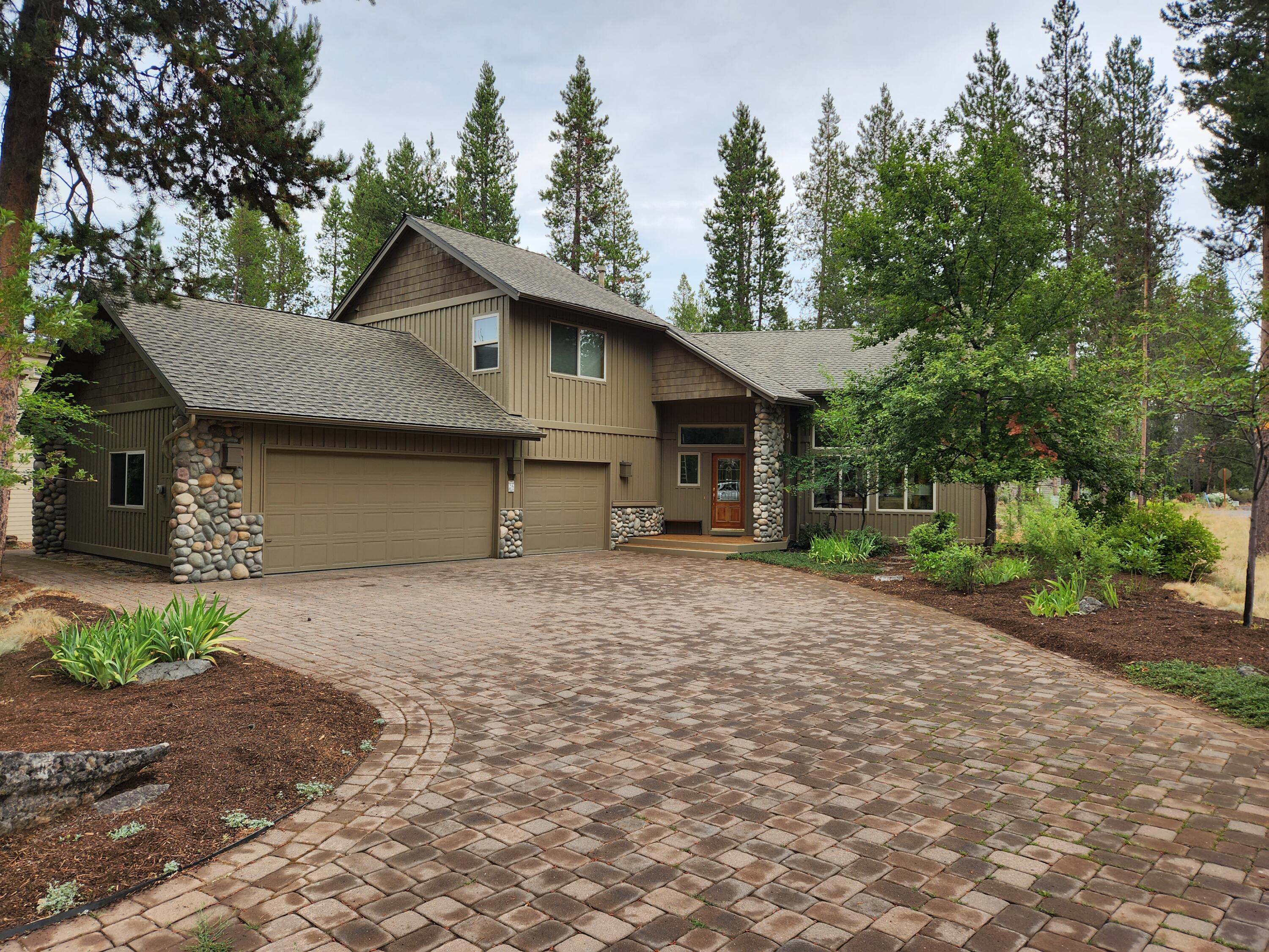 Welcome to this amazing Sunriver NW Lodge style home located in a Great Central Location! The main level living offers convenience, while the floor to ceiling river rock gas FP in the great room creates a cozy atmosphere. Abundance of natural light & views of the surrounding trees & wildlife through two-story windows. The main level primary suite is a true retreat, featuring an updated bathroom w/ zero entry tile shower, quartz countertops, & even a Japanese toilet. The sunroom adjacent to the suite can serve as an office, exercise area, or your personal sanctuary. Step out onto the deck area from the sunroom & enjoy a private hot tub area. The kitchen boasts granite counters, SS appliances, & center island, making it a culinary enthusiast's dream. Upstairs, you'll find a 2nd suite & 3 add'l guest rooms, along w/ a full bath in the hall. Heated 3 car garage w/ a workbench provides ample space for your vehicles & projects. Tons of storage, A/C.
