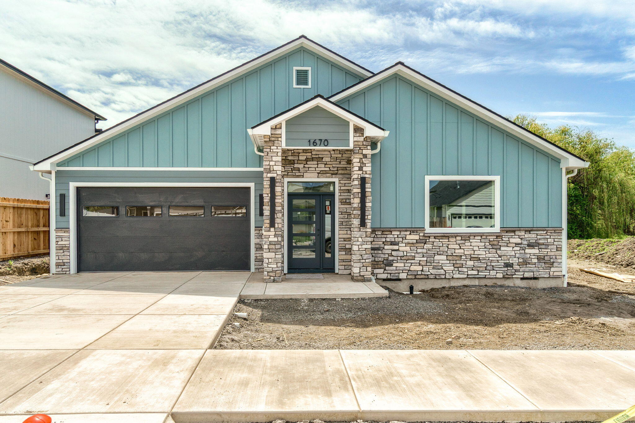 Stunning new construction in East Medford with up-graded contemporary finishes throughout! Estimated completion is June 2025 -This single-level home will capture your attention with its open-concept design, durable laminate flooring, vaulted ceiling and plenty of natural light. The spacious kitchen features wood cabinetry w/soft close drawers & pull outs, a large island, quartz countertops, stainless steel appliances, and beautiful tile backsplash. The bathrooms include tile flooring, custom tile shower surrounds, quartz counters, and stylish mirrors and fixtures. Enjoy the benefits of energy-efficient living with a tankless water heater. The indoor laundry room incl. a sink, countertop space & ample storage. Step outside to a covered patio that backs to tranquil wetlands—no rear neighbors for added privacy! The yard will incl back yard fencing & low-maintenance landscaping front & back. Generous two-car garage with possible attic storage. Shown by appointment only.