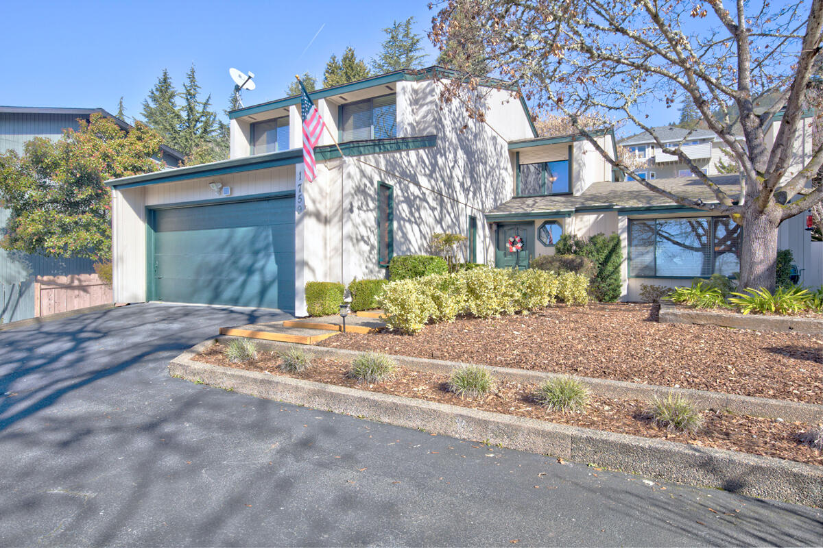 Beautifully maintained 3 bedroom 2 1/2 bath in a great location, near city center and all of the services that Grants Pass provides.  With all new flooring and entire interior painted in 2019, this home has a formal living area with wood fireplace, beautiful formal dining room, a spacious eat-in kitchen with breakfast bar, plus a large family room with access to patio and a very private and thoughtfully landscaped park-like backyard. The upper level has a split floor plan with two full baths and lots of storage. The laundry room with brand new washer & dryer, is perfectly situated off the finished oversized 2-car garage.  Property has  2 extra off-street parking spaces. The home is located in a neighborhood of stunning homes with amazing views and it is a decorator's dream. Seller is offering a one-year home warranty. Come and view this unique and lovingly cared for home. It will not disappoint.  BETTER THAN THE PICTURES!