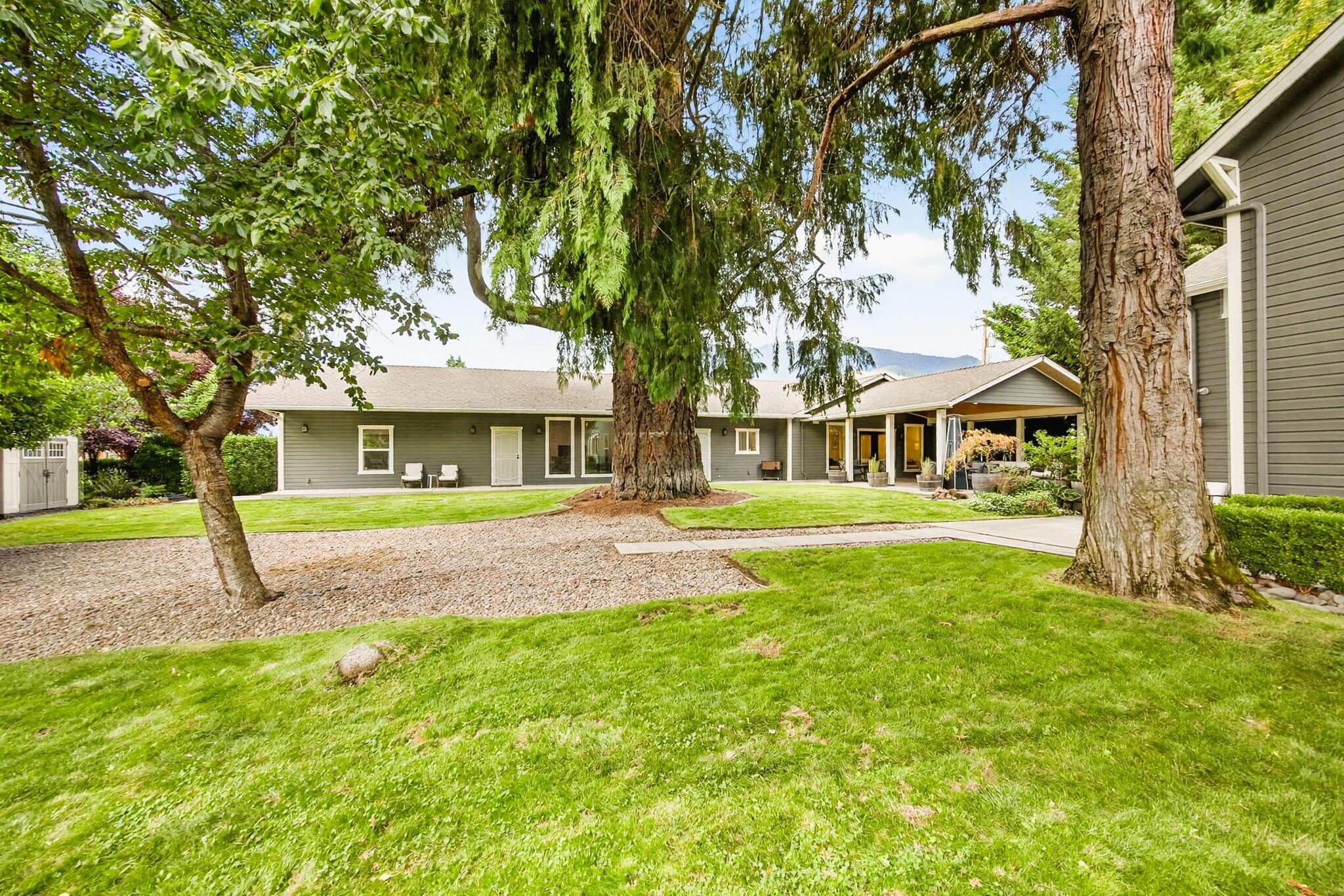 A rare opportunity in the heart of Rogue River! This exceptional 4,604 SF property, set on a .41-acre corner lot with coveted C-1 zoning, offers one of the most flexible designations available—ideal for retail, office, professional services, creative spaces, or mixed-use development. Over $400K in renovations have transformed the property, blending historic character with modern systems and finishes. The main building includes 3 offices/rooms, 2 full baths, 2 half baths, open-beam ceilings, granite counters, new appliances, and a suite with stone soaking tub, tiled shower, laundry chute, and walk-in closet. The fully renovated 2,504 SF detached building provides a kitchenette, office, conference room, full bath, gym, open workspace, and music studio with double 2x6 walls and recording booth. Outdoors, a pavilion-style entertaining patio, fully fenced landscaped grounds, and a magnificent heritage tree create a welcoming and professional setting. Book your personal tour today!