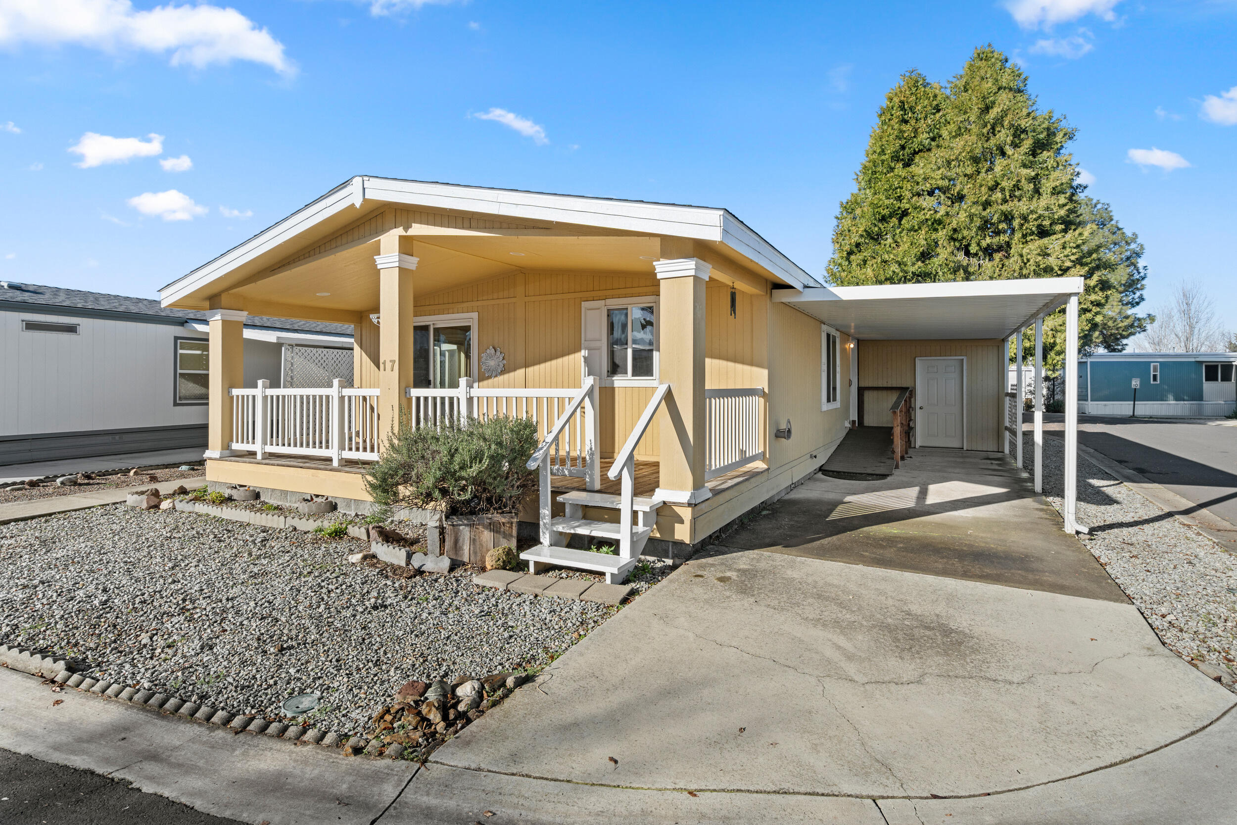Well maintained home in Glenwood Mobile Home Park.  This 55 and over park offers a club house and pool.  The home features a spacious primary suite with 2 closets, walk-in shower and plenty of natural light.  The 2nd bedroom is nicely sized.  Bonus room can be used as an office or den is also included.  Kitchen has breakfast bar, pantry, includes appliances and plenty of storage.  The living room has vaulted ceiling, natural light from the well- placed windows and access to the covered porch via sliding glass door. Covered carport makes accessing the laundry room/mudroom by the newer ramp a breeze.    Mature landscaping and a storage shed are also included. Home is wired for a full house generator.