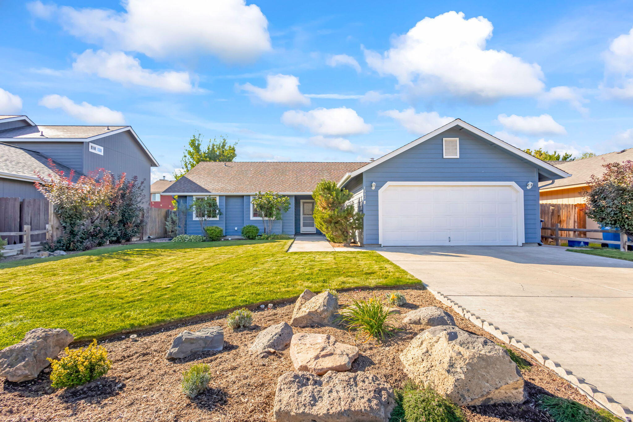 Light and bright single level living in NW Redmond with brand new roof! This floor plan offers an open great room with large kitchen and spacious dining/bonus areas. Kitchen counter seats 5+...a perfect entertaining space.  You'll love the amount of natural light from all of the windows! Mud/laundry room off of garage provides ample storage space for shoes, snow gear, and more - with a window to the front entry, could even be a small office or crafting space. Two bedrooms at the front of the home have deep boxed windows that bring so much character inside and out. Primary bedroom sits at the back of the home. Primary en suite has 2 closets and walk-in shower. Outside patio is south facing - lots of sun all year long! Beautiful and simple landscaping is ready for you to enjoy. Fabulously located just 2 blocks from the new Dry Canyon Club and less than 1/2 mile from the Dry Canyon trailhead at Canyon Rim Park!