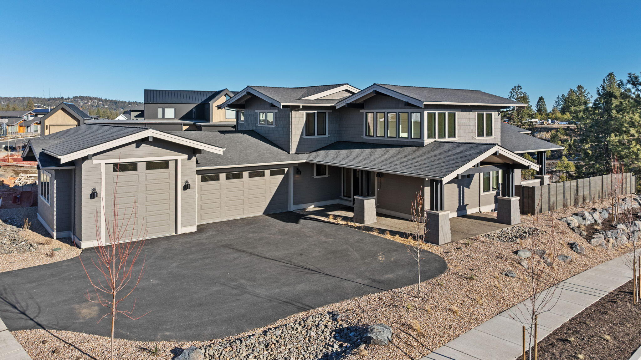 Located on a corner lot that backs up to the 40-acre Discovery Park, this Modern Craftsman home has a light-filled, open layout ideal for living the active Bend lifestyle. The welcoming great room has a gas fireplace and floor-to-ceiling windows overlooking a large patio—which has a built-in gas fire pit—and the park beyond. A designer kitchen has a center island with seating and large butler pantry with storage, prep area and sink. The main-level primary suite has patio access, a walk-in shower, soaking tub and large walk-in closet, and a main-level study has natural light. Upstairs, there is a secondary suite, third bedroom, third full bath and flex space. This well-designed home connects the spacious garage—which has a third bay with a 10' overhead door, ideal for an adventure vehicle—with the living area via a laundry/mud room. Convenient to trails, parks and westside amenities, including NorthWest Crossing and The Grove, this home provides outdoor access and a sense of community.