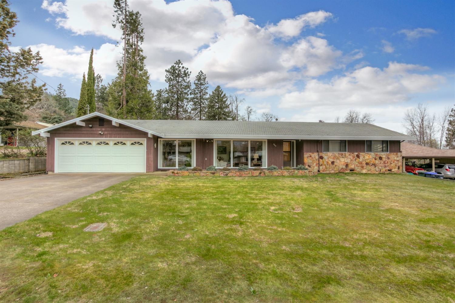 This house is a 1968 classic: ranch style, desirable neighborhood on a spacious, flat .68 acre lot with T.I.D irrigation, zoned R-1-7.5. Other features include large picture windows, 1726 square feet with 3 beds & 2 baths. The layout works well for either a couple or a family with plenty separate spaces to enjoy: large kitchen, formal dining and a large living room/family room. Additionally we have an over sized 2 car garage, a laundry room, an additional mud /storage room to come in and out the back yard. The home was solidly built by the current owner and impeccably maintained by him since then. Step out the dining room doors to a sizable Port Orford Cedar deck which looks over the back yard where a magnificent blue spruce tree presides. At the rear of the property is Clay Creek, which runs year round. A classic house with views, in a beautiful neighborhood. Close to town & trails. This spacious lot has may possibilities, buyer to due own diligence.