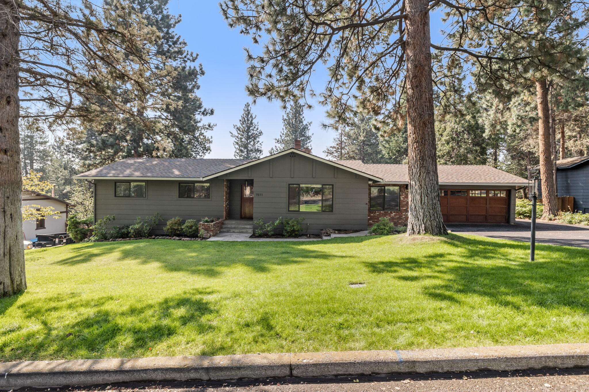 Ease and comfort await in this beautiful West Hills oasis. Situated on a large level lot surrounded by old growth ponderosa pines, this recently updated single level home offers quiet and privacy while being just a short walk to the shops and restaurants along Newport Ave, the Galveston corridor and downtown Bend. This light and bright home features white oak hardwood floors, new windows, new lighting, recently painted exterior, kitchen with quartz countertops, stainless steel appliances and open shelving. Expansive deck overlooks the fully fenced backyard. Finished space on lower level with separate entrance opens to the back - perfect for art studio, office or game room! Recently paved driveway and RV parking area round out this incredible home.