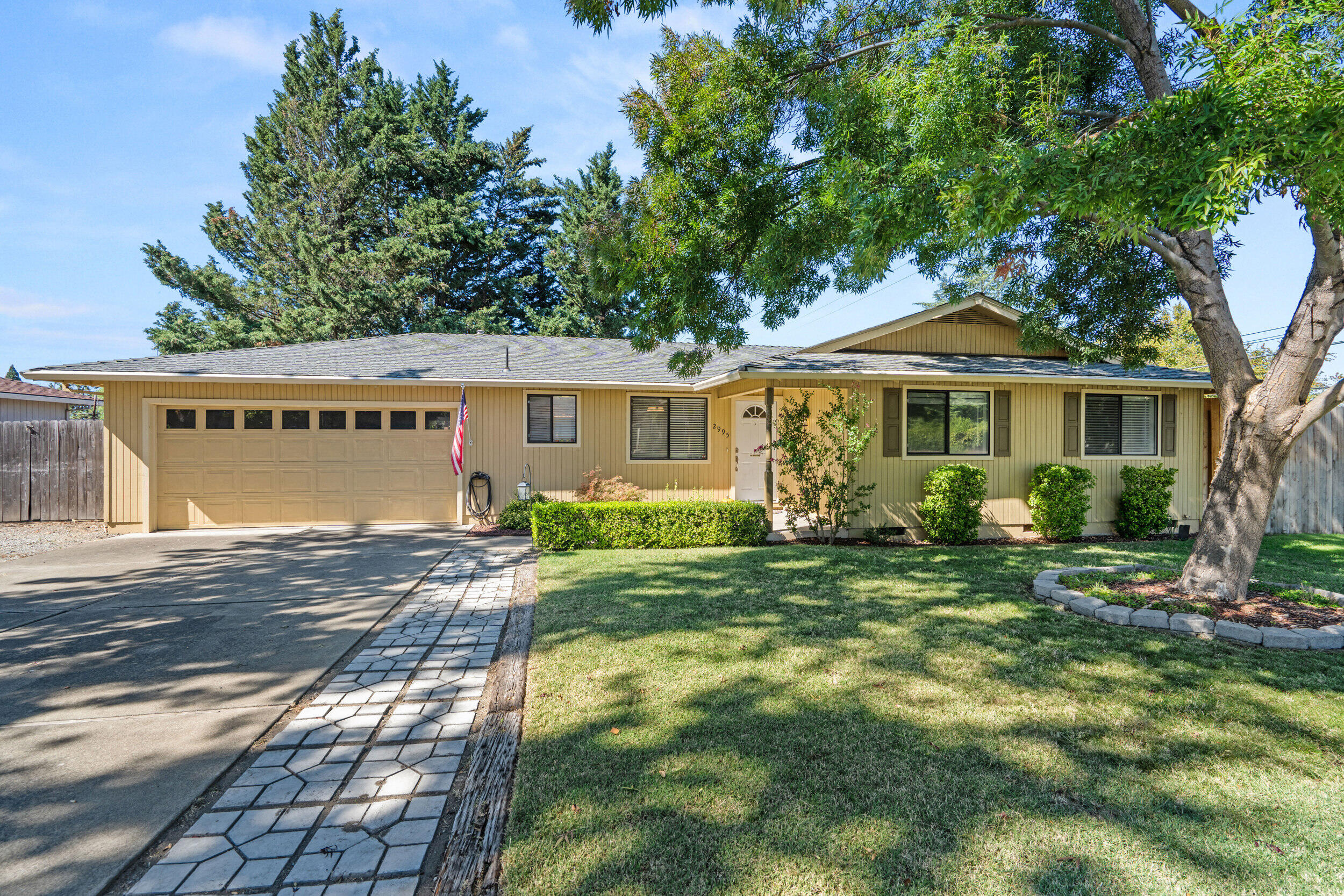 *Includes Home Warranty* Nestled in a quiet cul-de-sac just below the foothills, this single-level home on a .26-acre corner lot blends privacy and convenience. Solidly built with quality construction you don't find in modern builds, it offers easy access to shopping, hospitals, the airport, and mountains while remaining a peaceful retreat. The thoughtful layout includes a large living and dining area centered around a charming brick fireplace—perfect for entertaining or cozy family nights. The updated tile-and-granite kitchen and bathrooms feature a luxurious soaking tub under a skylight and a walk-in shower. LVP flooring runs throughout, adding style and resilience. An 8-ft privacy fence encloses a massive backyard with mature trees, a garden, and updated irrigation. Unwind in the hot tub under the pergola or plan adventures with gated RV parking. A 2-car garage, shed, and gutter guards make this move-in-ready haven ideal for families, outdoor enthusiasts, or retirees