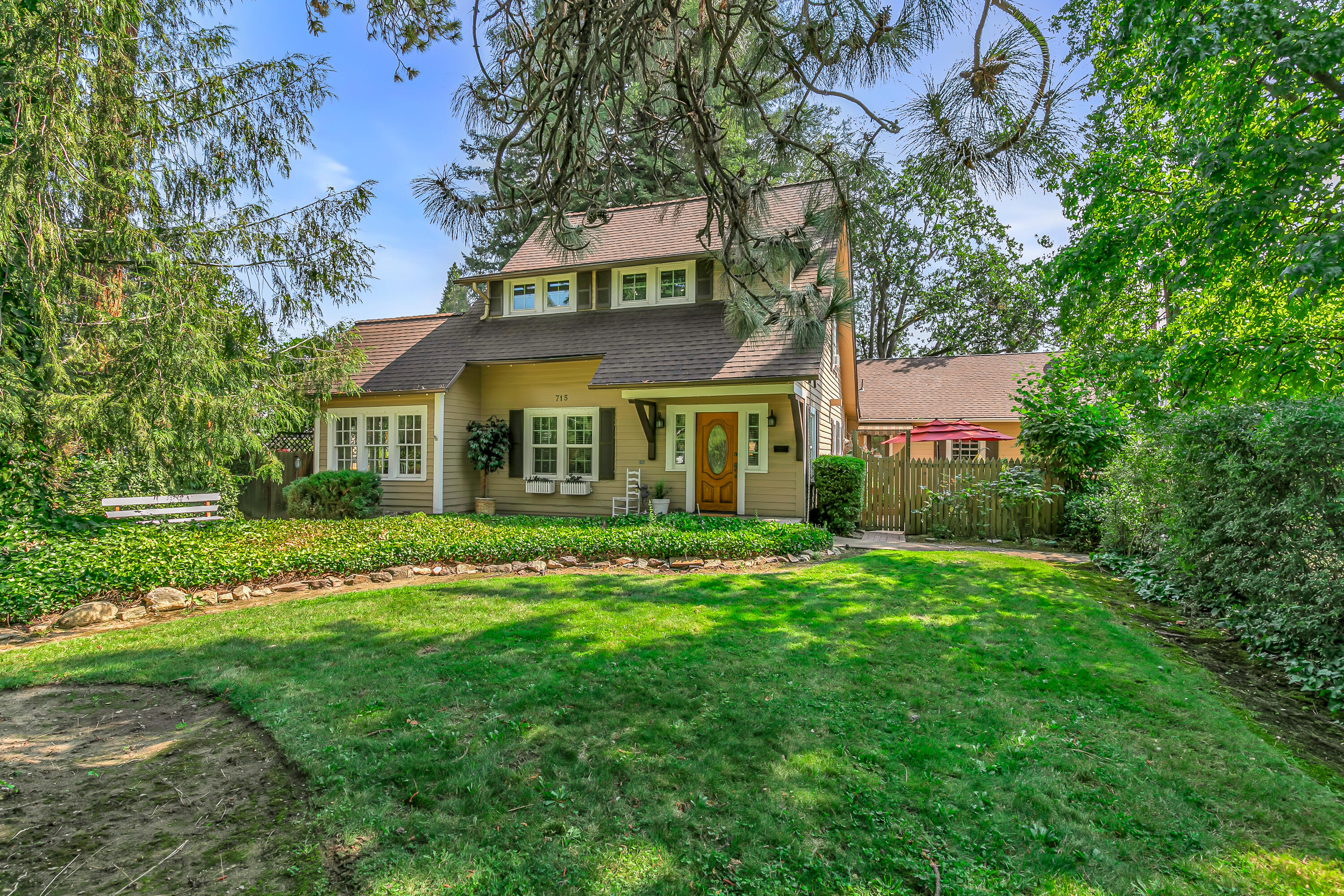 Nestled along the tree-lined streets of Medford's charming South Oakdale Ave, this classic 1930 home is a lovely sanctuary in the heart of town. From the moment you arrive, you'll appreciate the privacy provided by mature landscaping on a well-manicured, oversized lot. Inside you'll find arched doorways, a flexible bonus space, & beautiful oak flooring that flows throughout the main level. In the kitchen, you'll find leathered granite countertops, tiled backsplash details, a gas stove and tons of storage. The bathrooms also retain the home's historic integrity while offering contemporary comfort. A true highlight of this property is the income-producing Airbnb unit, complete with its own private entrance—perfect for guests, extended family, or extra monthly income. Additional updates include fresh interior paint, a new water heater replaced in 2022, updated electrical & plumbing, and recent Roof Maxx treatment. Come see for yourself all the charm and character this home has to offer!