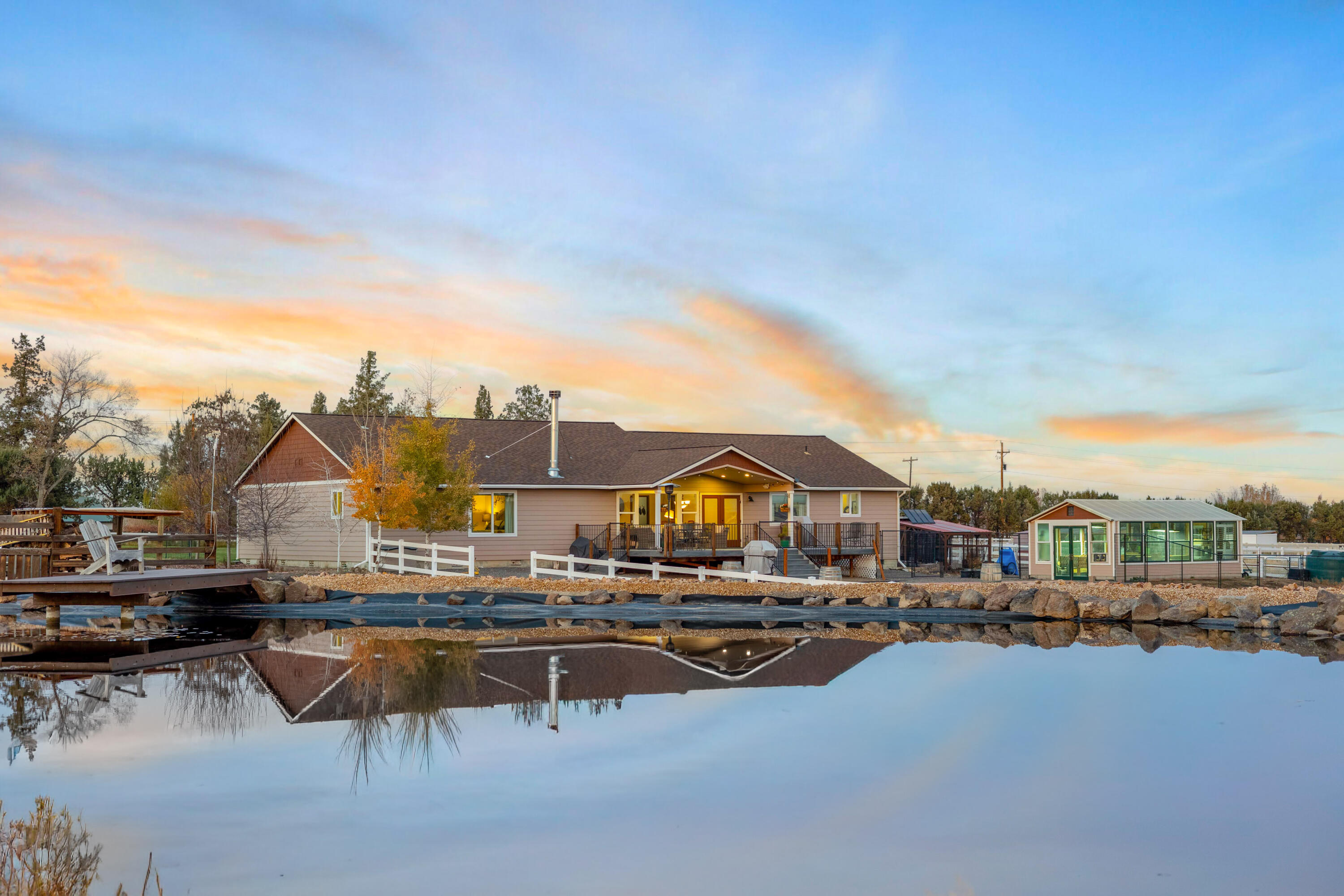 Experience the best of Central Oregon living on this 21-acre estate just minutes from Tumalo and Bend. The 2,558 sq ft Hi Line home (built in 2018) features two spacious primary suites and a refined, comfortable design throughout. A decommissioned 1940s, 2-bedroom home offers excellent potential for repurposing. The property includes 16 acres of irrigation rights, a pond, and a greenhouse with geothermal heating—ideal for gardening or small-scale farming. A versatile outbuilding provides shop space plus a workout/media room for hobbies and storage. Private, peaceful, and conveniently located, this property offers flexibility for luxury living, homesteading, or creating a unique retreat. Schedule your private tour today.