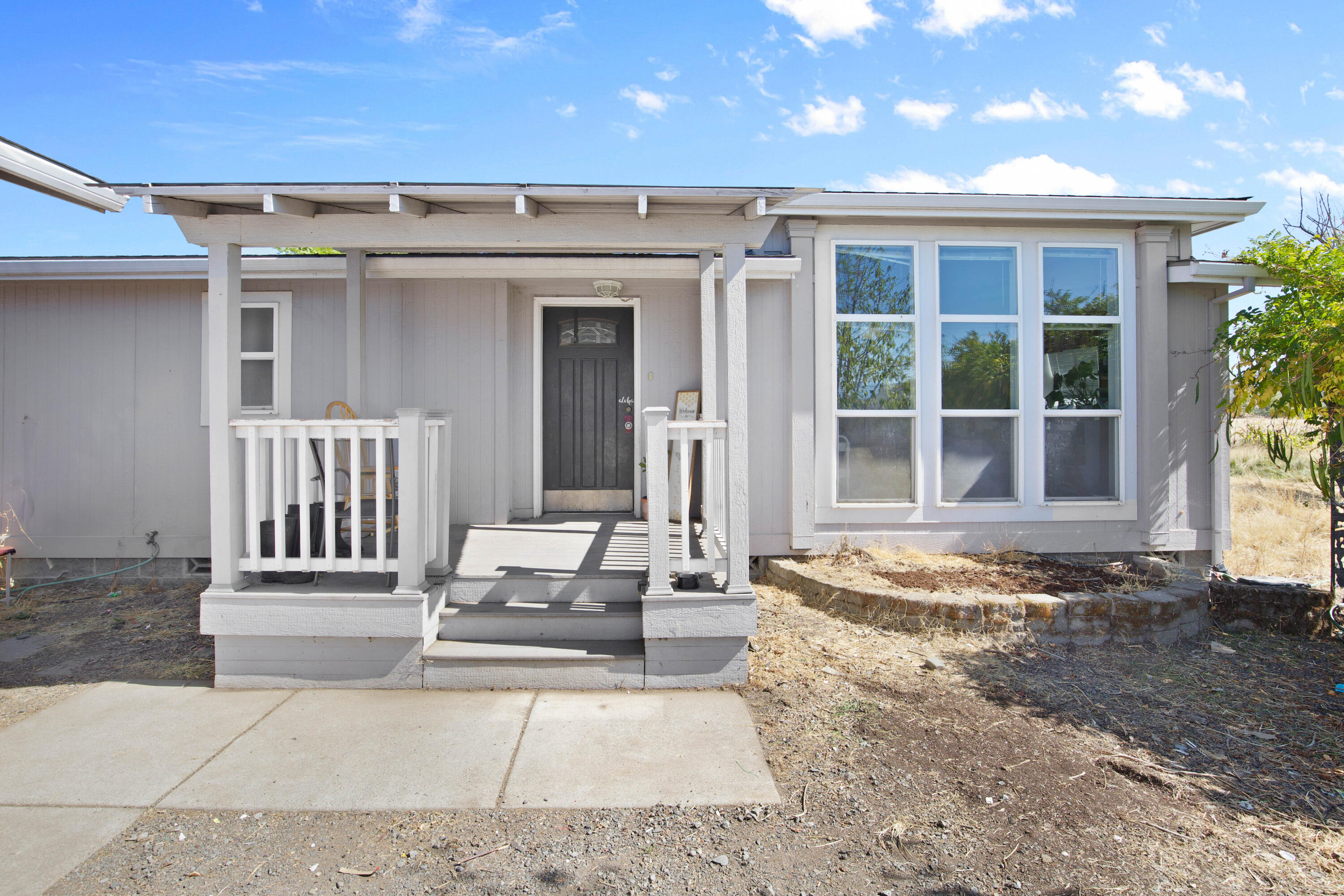 Enjoy the best of country living just minutes from town! This 3-bedroom, 2-bath, 2,114 sq ft home sits on 3.67 acres and offers a versatile, inviting floor plan. Inside, you'll find a dedicated office, spacious mudroom, and abundant natural light throughout. The property is fully fenced and cross-fenced with a small barn, making it ideal for horses, livestock, or hobby farming. A detached 1,008 sq ft garage provides ample room for storage, a workshop, or extra vehicles and equipment. Whether you're seeking space to spread out, room for animals, or a peaceful rural setting, 6600 McLoughlin Drive delivers it all.