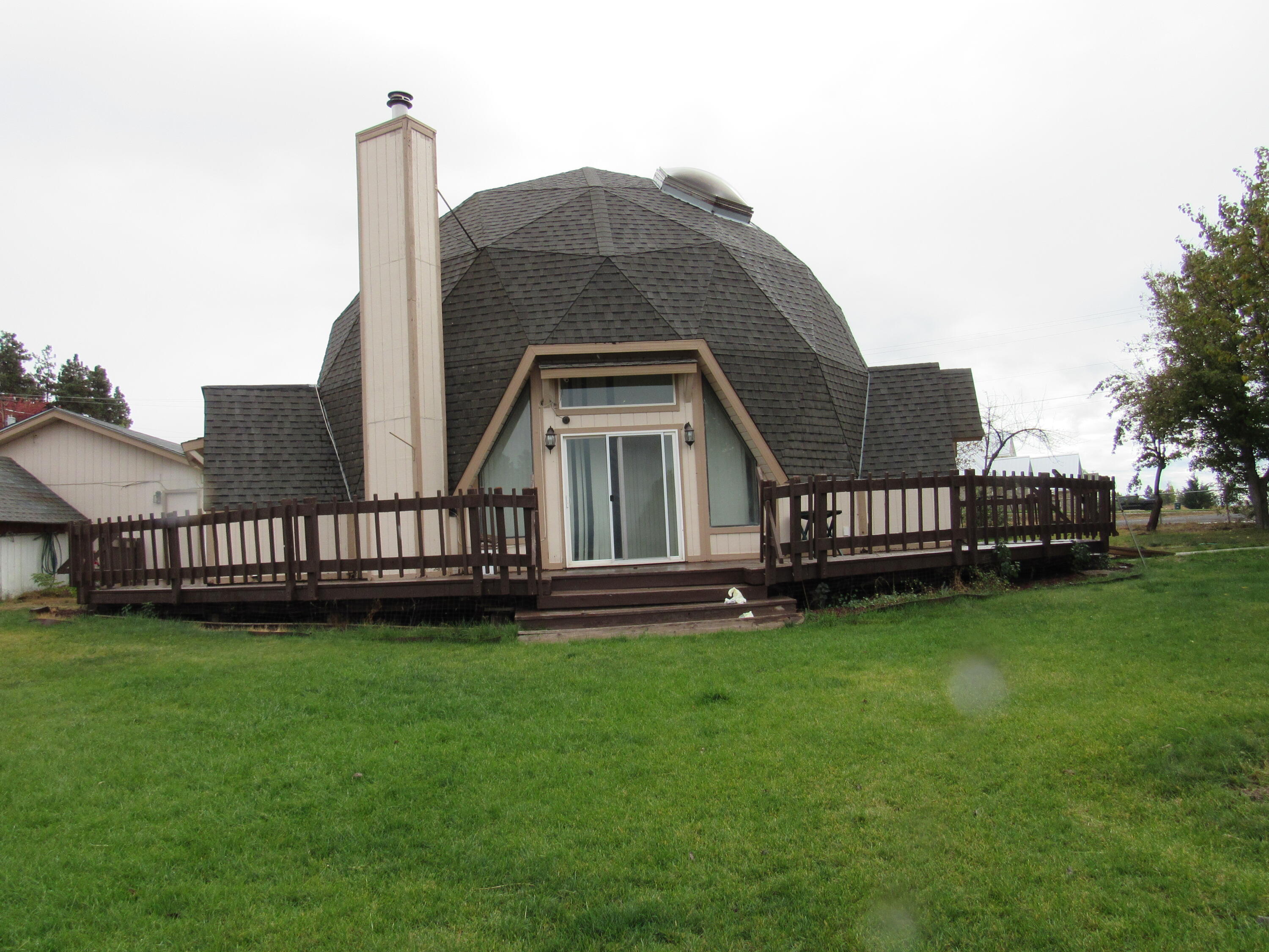 Great opportunity to make this unique home yours.  There are some things that need repaired and the seller is unable to do them. Home is livable just needs some TLC. The home is a Dome Home so if you ever wanted to see inside a dome home now is your chance!!  A 2 car garage with a  storage building and a car port.   Nice yard all fenced with several fruit trees and a nice group of spruce trees. There is a master bedroom and another downstairs with two more bedrooms upstairs. Agency Lake is across the street with access to a public boat ramp and also a camping facility on the lake.  BRING ANY OFFER