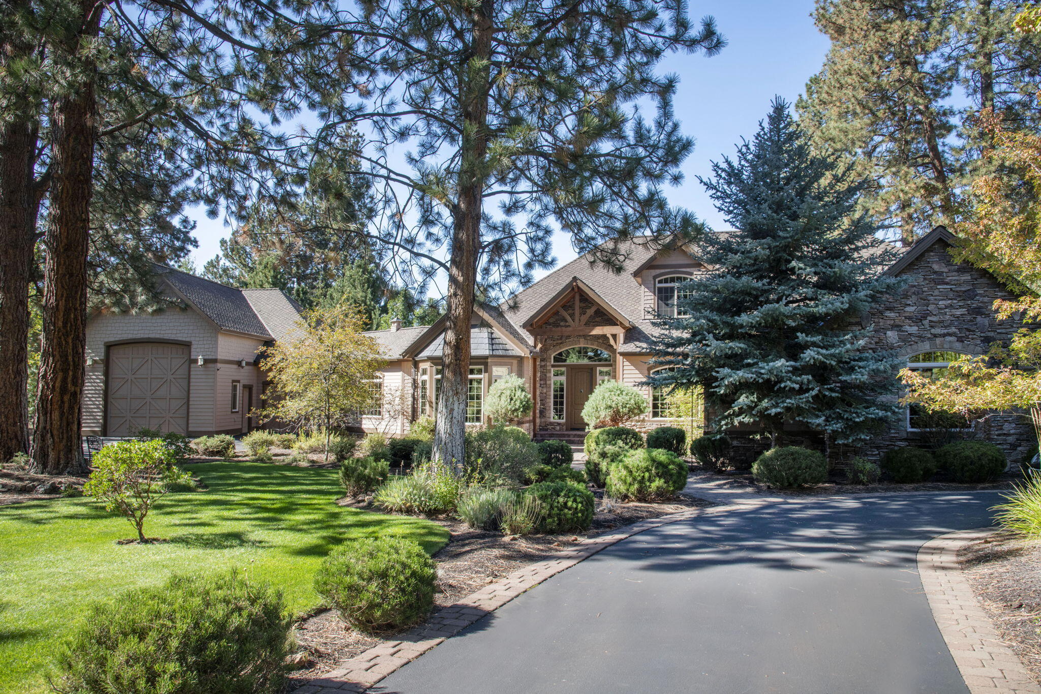 Come home for the holidays to this absolute masterpiece. Timeless NW custom design throughout featuring knotty alder woodwork, 8ft interior doors, travertine tile and a spacious main floor. The gourmet kitchen features double dishwashers, granite counters, oversized island, warming drawer, Wolf appliances and heated tile flooring. The light filled great room features a beautiful stone fireplace with a juniper mantle, wet bar/dishwasher, built-ins and massive windows making it perfect for entertaining. The luxury primary features a fireplace, walk-in closet, jetted tub and an oversized walk-in shower. The second floor provides separated living with 2 additional bedrooms, full bath, loft and ample storage as well as a second floor deck. This beautiful home is situated on the Lost Tracks golf course. There is a 3-car garage with additional attached RV garage with 14ft doors to fit a 45ft motorhome. This is truly a one of a kind you must see!