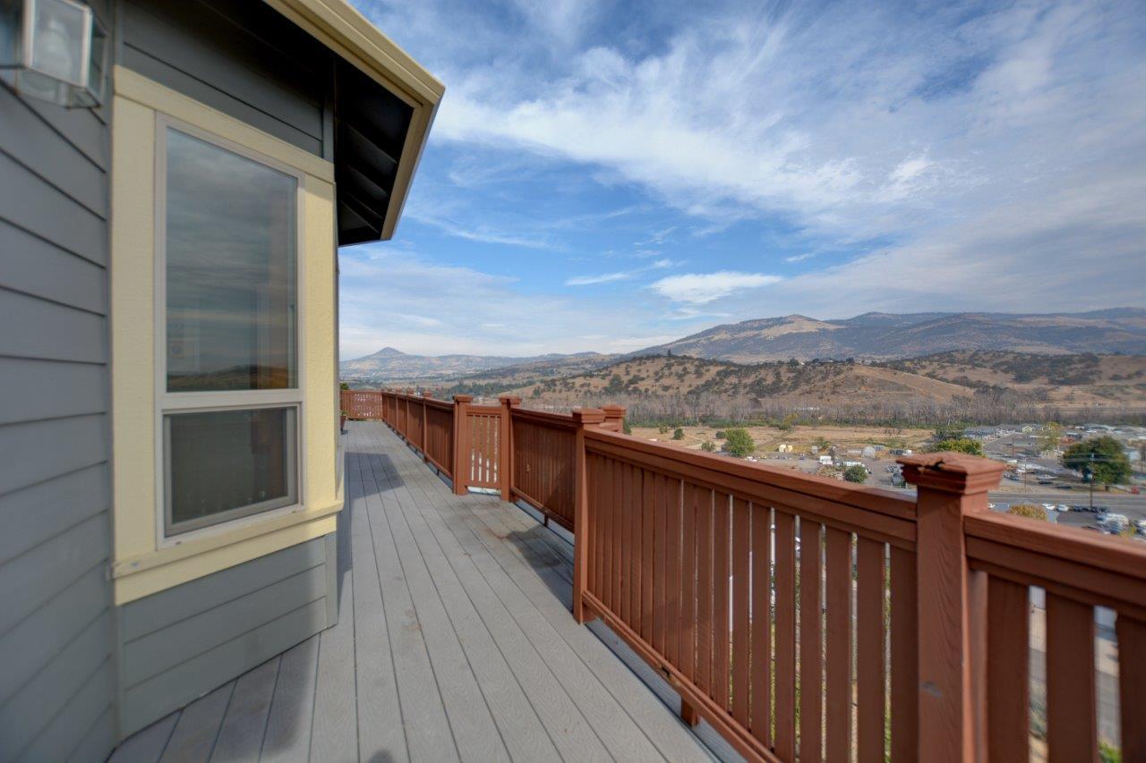 Views! Come see this amazing home with views of the valley. Fire concerns? Home has residential sprinklers! Large 3,698 sqft home with 4 bedrooms and 3 baths, that sits on top of the hill. Custom Rock work and covered entry welcome you to this beautiful home. Main level includes office, 1-bedroom, primary bedroom, kitchen, living and family room and formal dining. Large living room with see-through fire place and open-floor plan connect to kitchen. Kitchen has cherry cabinets, granite counters and stainless-steel appliances. Large decks on both levels take advantage of the views. Primary bedroom has deck access, walk-in closet, double-sink, walk-in shower and soaking tub. Downstairs has 2 large bedrooms, laundry room with laundry chute, 2nd living room with fire place, and oversized garage. Garage has extra space on both sides. Large lot, 0.32 acres and is landscaped, including outdoor fire pit. Schedule showing today to see all this home has to offer and to see the amazing views!