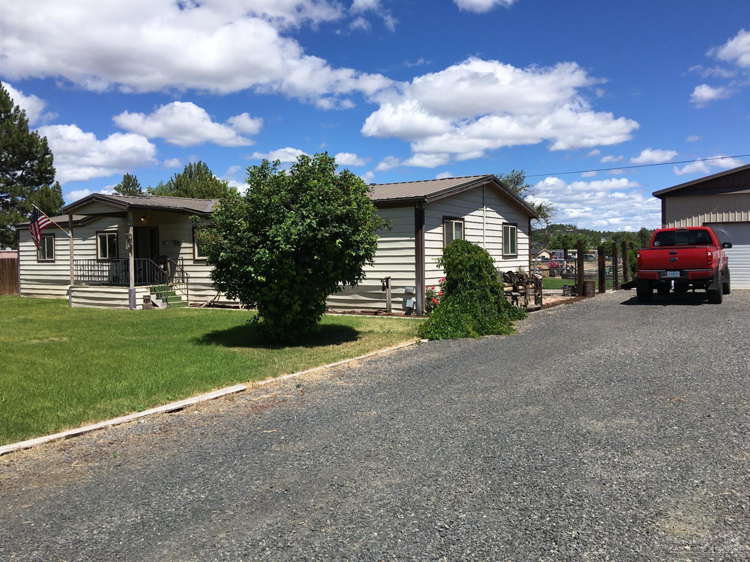 Fantastic corner lot on 3.22 acres. 3 acres of irrigated land & spacious 3 bedroom 2 bathroom manufactured home. Landscaped backyard featuring patio & deck with views of Barnes Butte. Large shop with room for an RV and 2 cars. Country living minutes from town.