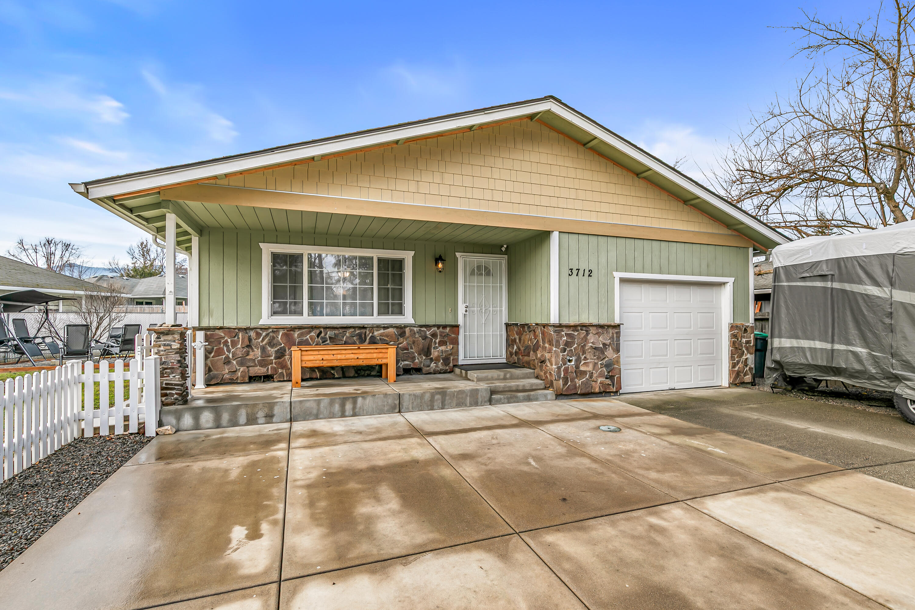 Welcome to this well-maintained 3-bedroom, 2-bath home ideally located in Phoenix, Oregon. Recent updates give this home a fresh, modern feel, including new interior paint and brand-new flooring in the living room and kitchen. The kitchen features granite countertops, offering both style and functionality for everyday living and entertaining. An oversized garage provides exceptional space for vehicles, storage, or a workshop. Outside, enjoy RV parking, a convenient storage shed, and a fire pit—perfect for relaxing evenings and entertaining guests. The thoughtful floor plan offers comfortable living areas and well-sized bedrooms, creating a home that feels both practical and inviting. Whether you're a first-time buyer, growing household, or investor, this property offers strong appeal. Conveniently located near schools, shopping, and local amenities, this move-in-ready home is a fantastic opportunity in the Rogue Valley.