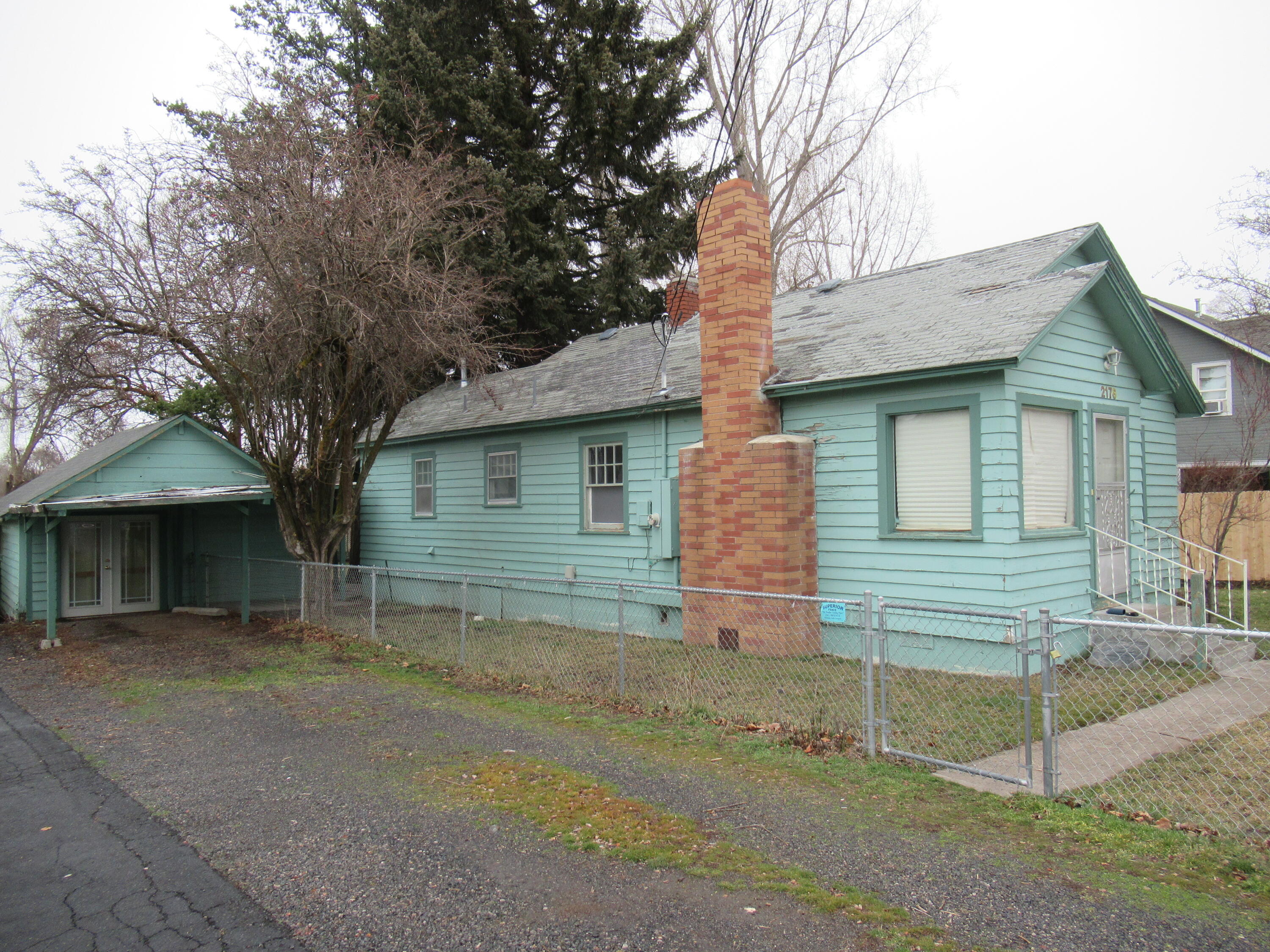 Step into this delightful 1930's residence, brimming with character both inside and out. This move-in-ready home offers a cozy atmosphere and the potential for personalization. Enjoy the fully fenced yard with mature trees, a generous front and backyard, and a quaint garage that can double as a hobby shop, workshop, or additional storage space.
