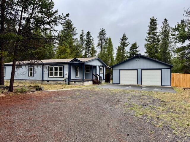 Privacy, Space & Recreation Close By. Enjoy the comfort of this well-kept 1994 manufactured home, nestled on nearly an acre of fenced and gated land. Set back for privacy, this home offers a spacious kitchen, laundry space and generous walk-in closets. The versatile garage/shop with loft storage is perfect for hobbies or extra storage. Just minutes from lakes, rivers, and outdoor adventures, this property blends convenience, space, and lifestyle.