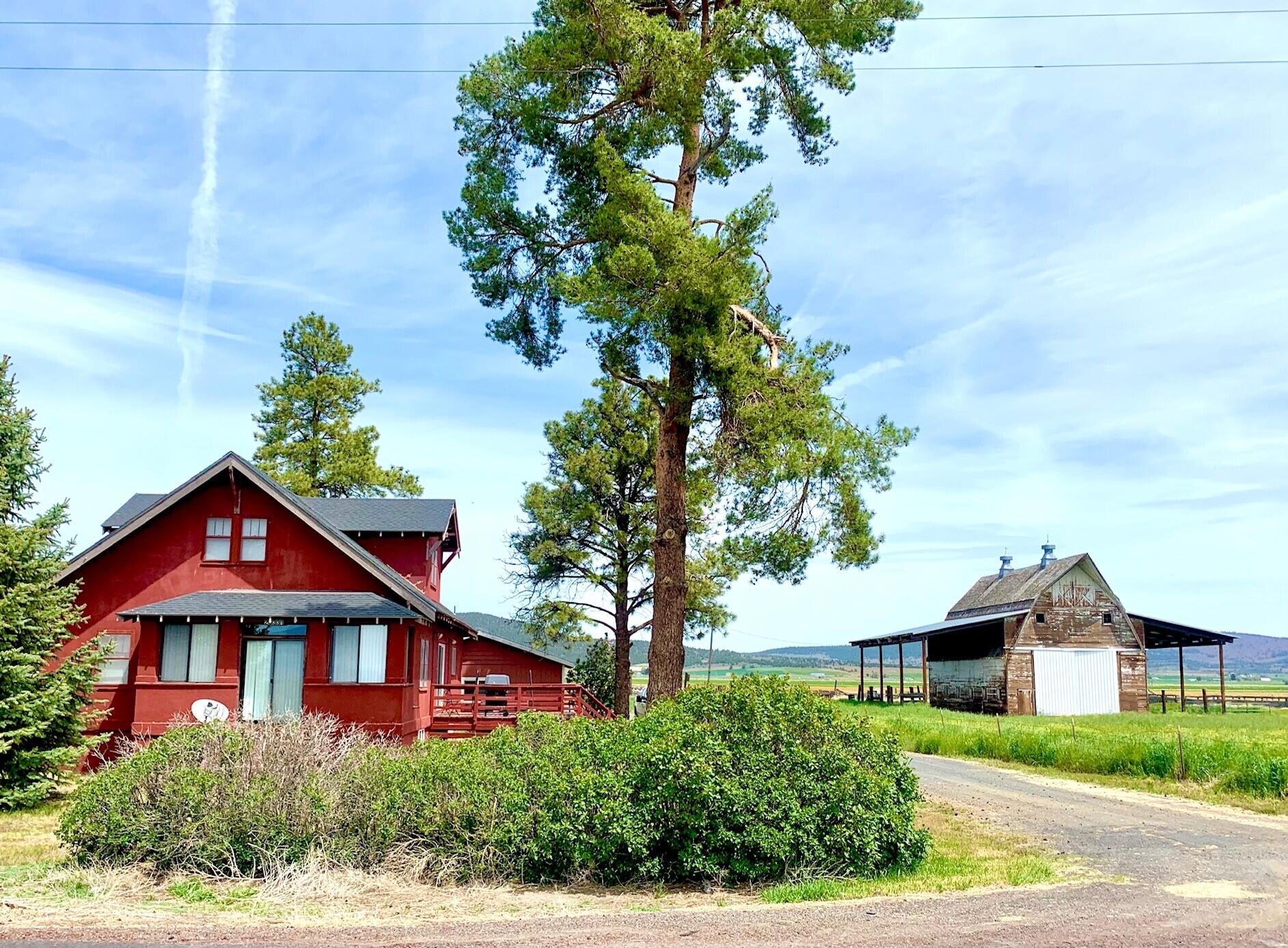 This 1930's farmstead sits on 78+ acres, and has loads of character and functionality. In addition to the charming 2,188 sqft farmhouse, there is a detached garage, shop building, a large ''chicken house'', grain silo, hay barn and of course the original gambrel roof barn. The home is spacious - with an open living and dining area, 5 bedrooms, 2 bathrooms, a large basement, and even a  walk in refrigerator/cooler! The property has KID A water rights and has some older corrals that could be fixed up for livestock. Make your appointment to view this great listing located between the small communities of Merrill and Malin, about 20 miles southeast of Klamath Falls.