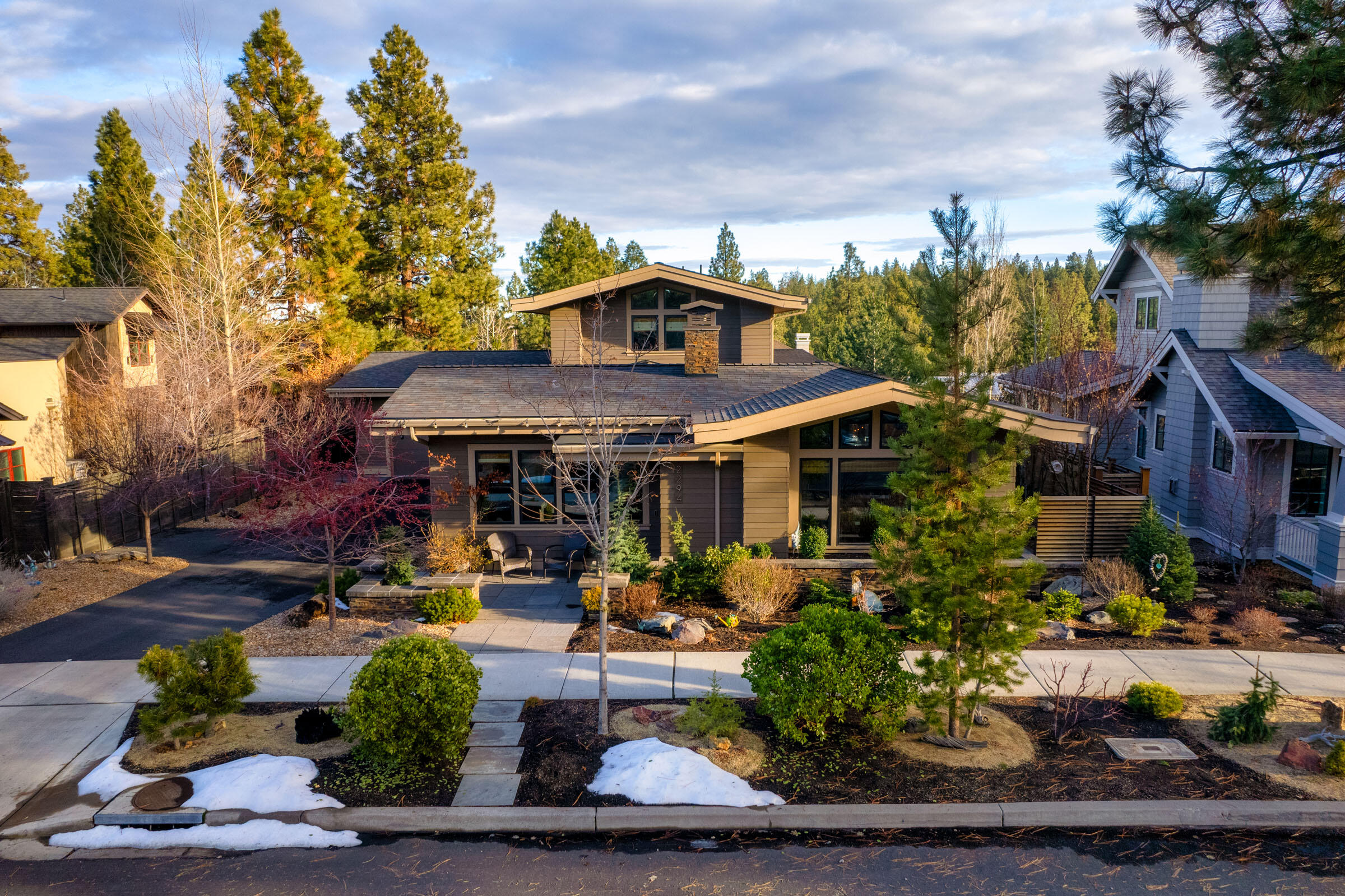 Welcome to this stunning Prairie-style home with a Modern flair, open concept living space, providing a harmonious balance of comfort and style with a double-sided fireplace between the kitchen and family room , floating staircase featuring a custom railing designed by Bend artist Andrew Wachs. Attention to detail extends throughout the home, with custom-built cabinets and storage solutions integrated into the living spaces. The exterior of the property is a true oasis with easy-care landscaping and carefully designed hardscape elements, a water feature, and a cozy fire pit surrounded by multiple lounging and dining areas. Enjoy  the outdoors from the backyard patios or upper deck, offering panoramic views that add to the charm of this residence. With an oversized 2-car garage plus 160 sqft of loft storage & built-in garage cabinetry.  Woodworkers, hobbyists, gardeners, and crafters will appreciate the heated 250 square foot workshop with 220v wiring. Walking distance to lots of fun.