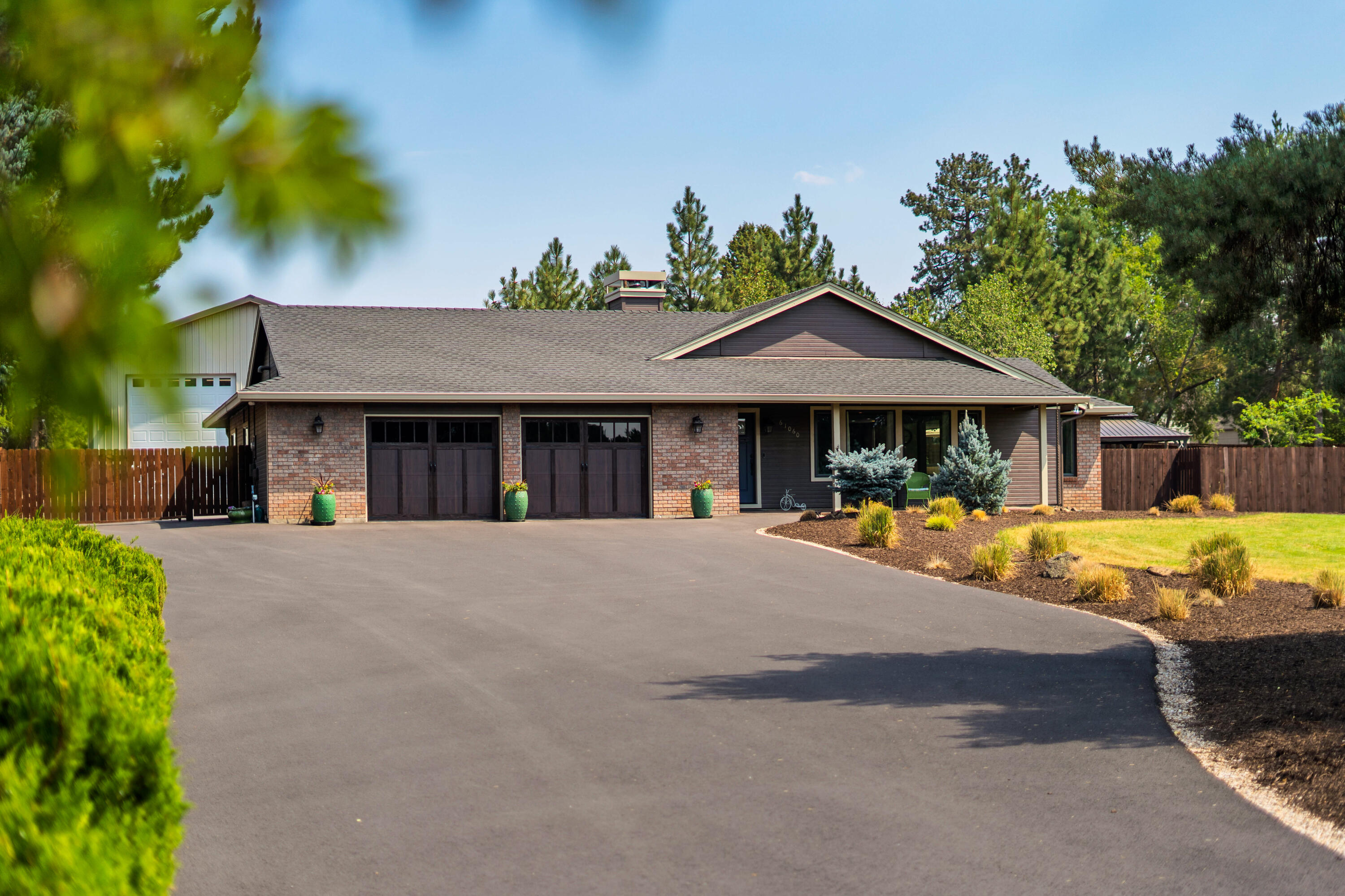 Private sanctuary in professionally designed backyard oasis, complete with custom outdoor kitchen, elegant water feature, night lighting, gas fire-pit, bocce field and a professional Pickleball court that can be used for other sports as well. All this surrounds a remodeled single- level 3/2 home with additional office, large mudroom, private hot-tub enclosure, great room with premium built-in sound system and oversized two-car garage. All appliances included. Spread out in the 1512 sq. ft heated/insulated shop with 14-ft pull-through RV space, and a second 10ft. door. Use as an exercise space, with mirrors on one wall and tons of room for any projects. Peace and quiet surround you in this established neighborhood with mature landscaping. Enjoy the tranquility of nature in the fully-fenced backyard with beautiful trees and flowers. Currently on septic but city sewer is easily accessible at the street if desired. Plenty of room for parking & room to grow! Truly a one-of-a-kind property!