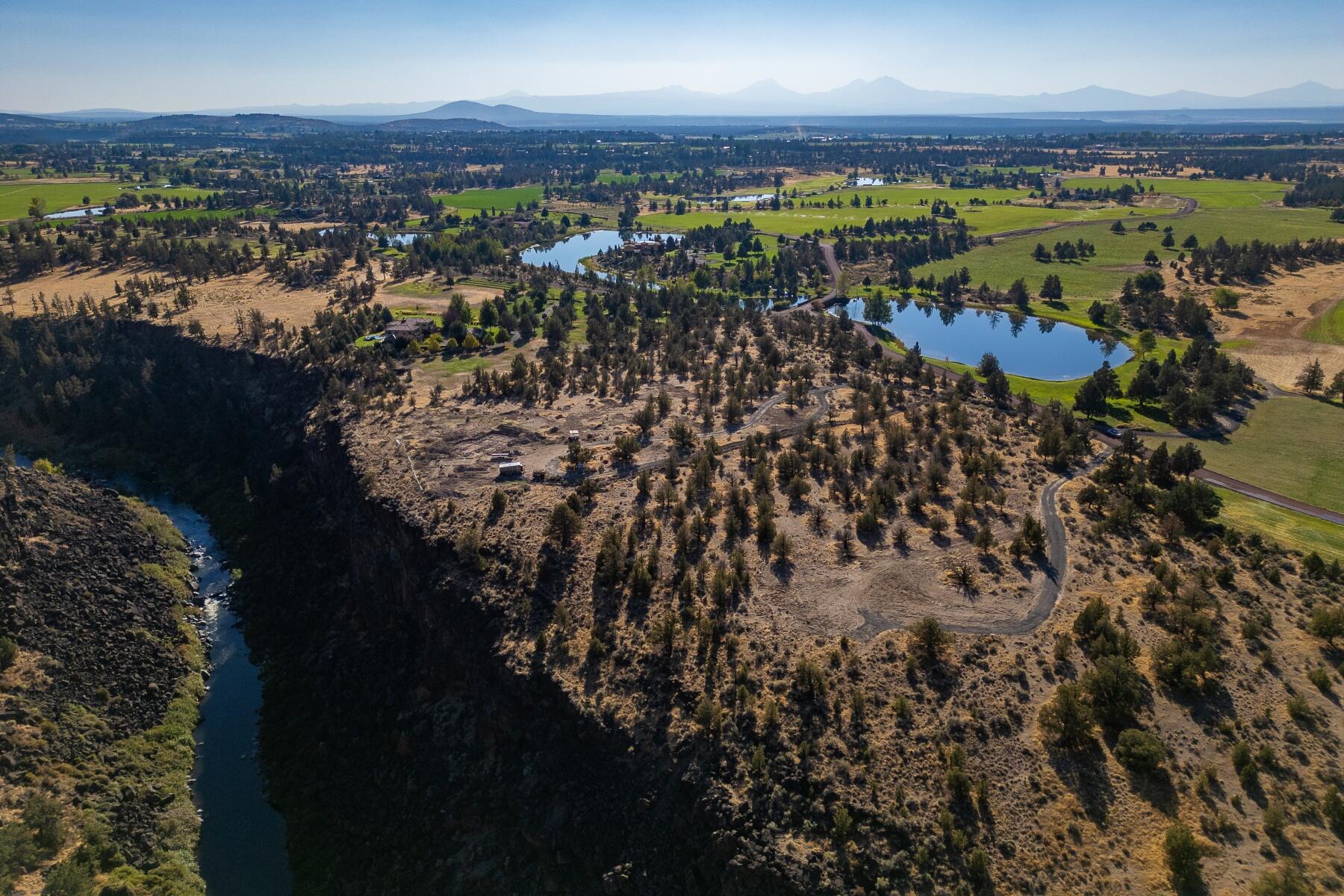 Set along the rim above the Crooked River, this 7.01-acre homesite captures wide-open views of Smith Rock and the canyon below. Within the private gates of Ranch at the Canyons, a 1,700-acre working ranch with only 46 landholdings, the setting offers both scale and quiet connection to the Central Oregon landscape. Owners enjoy access to the Old Winery Clubhouse and Guest Villa, equestrian facilities, vineyard, pool, and miles of scenic trails. Because the community operates as a working ranch, property taxes remain notably lower than comparable properties beyond its gates. HOA contributions support the care of the land, amenities, and enduring sense of place. A remarkable canvas for creating a home that reflects the beauty and spirit of Central Oregon living.