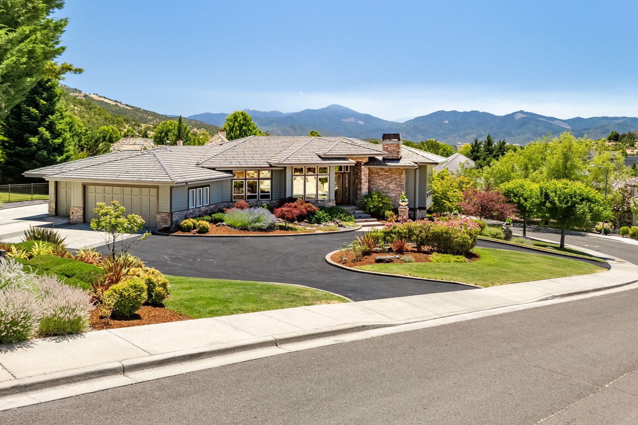Elegant Frank Lloyd Wright inspired architecture & design in this spacious custom built home in Saddle Ridge Estates. Open floor plan with stunning leaded glass entry, hand-hewn Cherry wood floors, custom built-ins & wonderful lighting. Great room plan with formal living & dining, in-home office, 3 ensuite bedrooms, 4.5 baths, family-rec room & great outdoor living. Center island Cook's kitchen with 6-burner Wolf cooktop & double ovens, KitchenAid built-in refrigerator, walk-in pantry, undercounter microwave, wine cooler & nook. Main floor primary suite w/double vanity, walkout Marble tiled shower, soaking tub & access to verandas. Granite counters & heated stone floors in the baths, lower level family-rec room w/wet bar, full bath and office/wine room. Private backyard with in-ground heated Gunite pool w/waterfalls, outdoor kitchen, Kohler whole house backup generator, RV parking, circular drive, mature landscaping, oversized 3-car garage, 500SF of unfinished storage & great views.